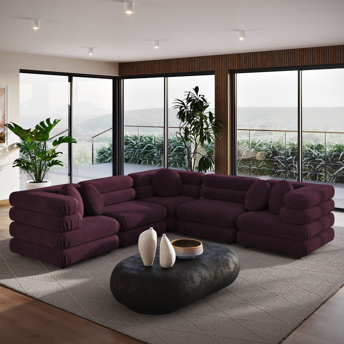 Mulberry performance velvet sectional anchoring a modern living room with floor-to-ceiling windows and lush greenery || EEI-7005-MUL || front_angle_room