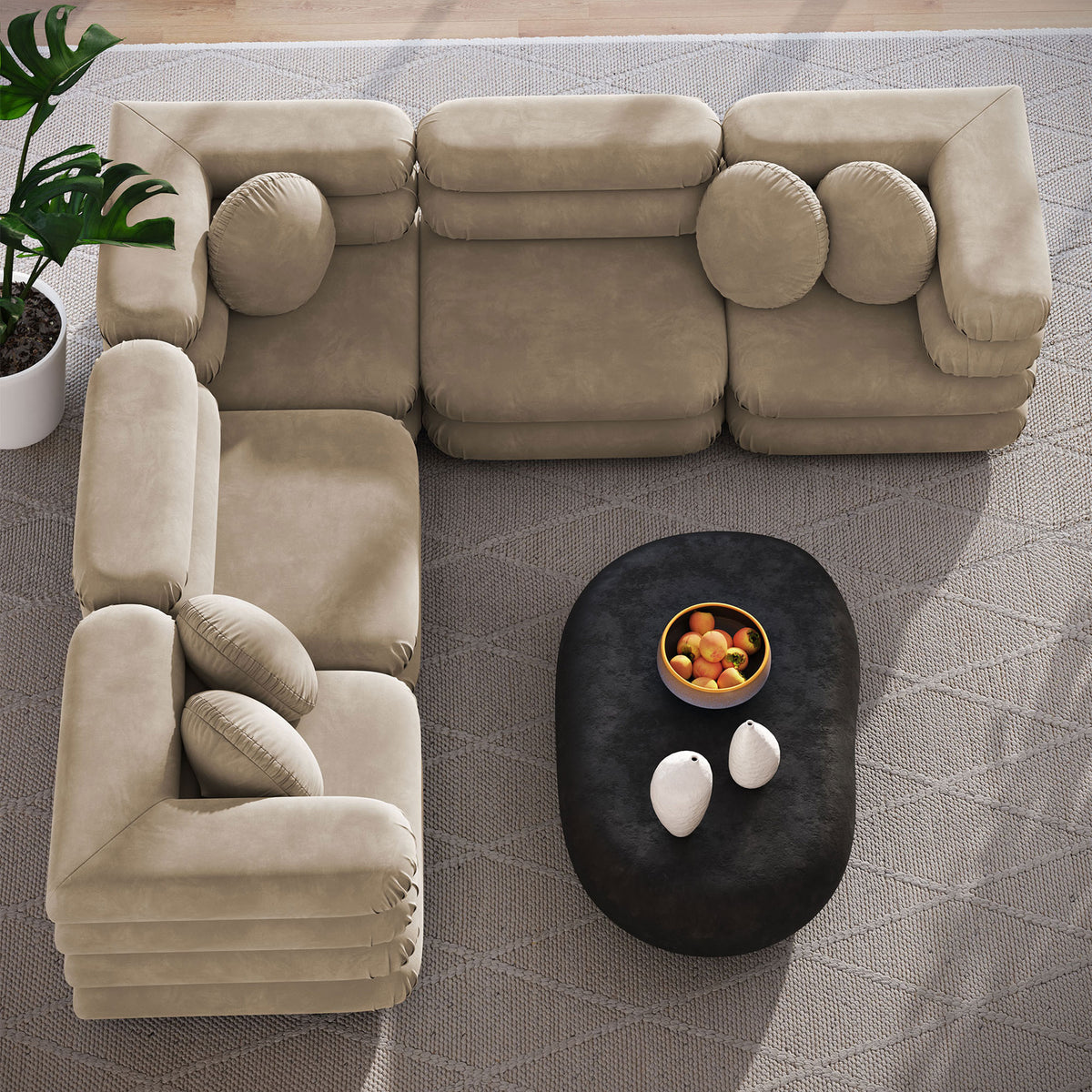 Taupe velvet sectional forming an inviting L-shape around a black coffee table on a textured rug || EEI-7005-TAU || top_angle_room