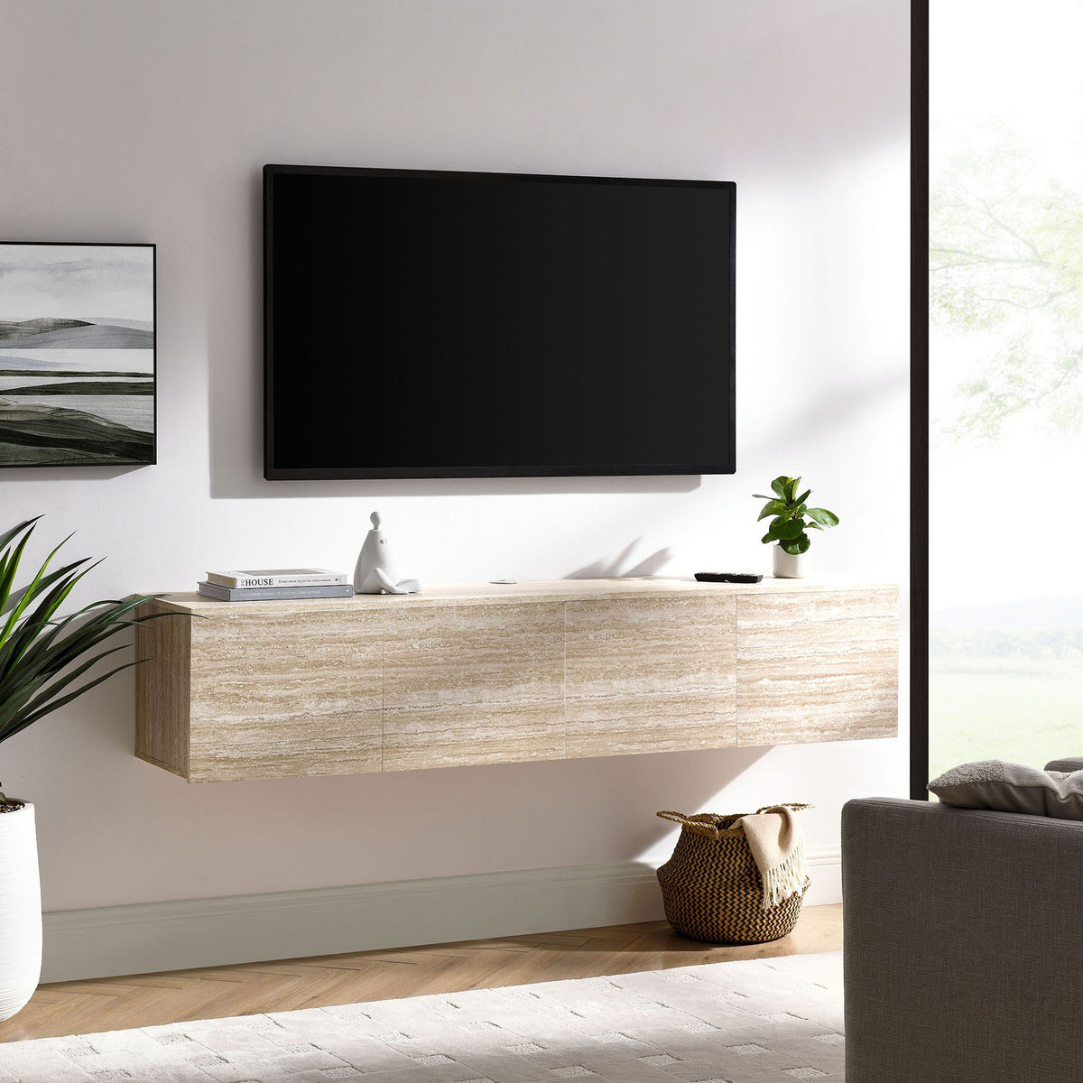 Floating TV stand styled in a bright living room beneath a wall-mounted screen and decor || EEI-7006-TRA || front_angle_room