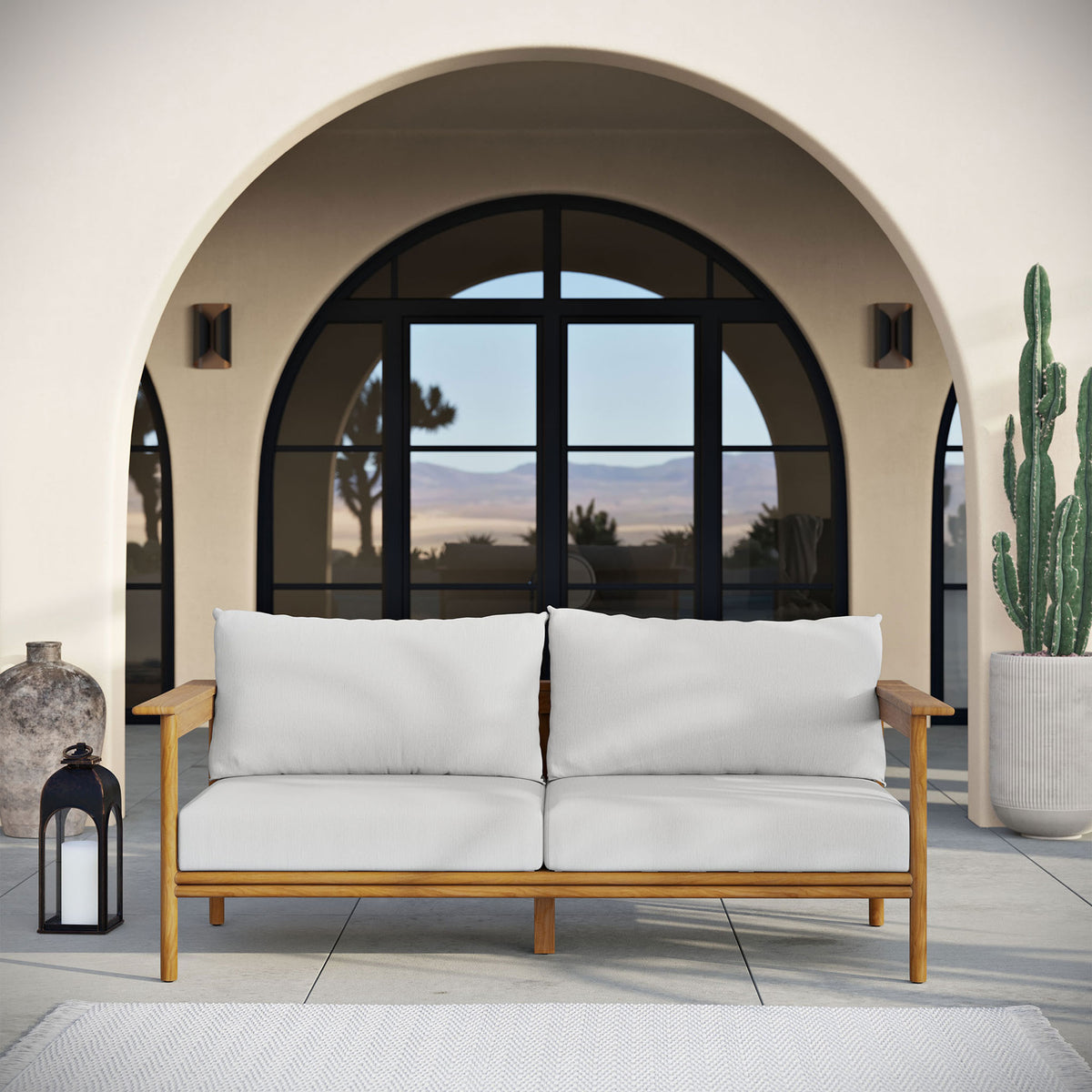 Teak outdoor sofa with white cushions creating a serene centerpiece on a modern arched terrace. || EEI-7008-NAT-SAI || front_room