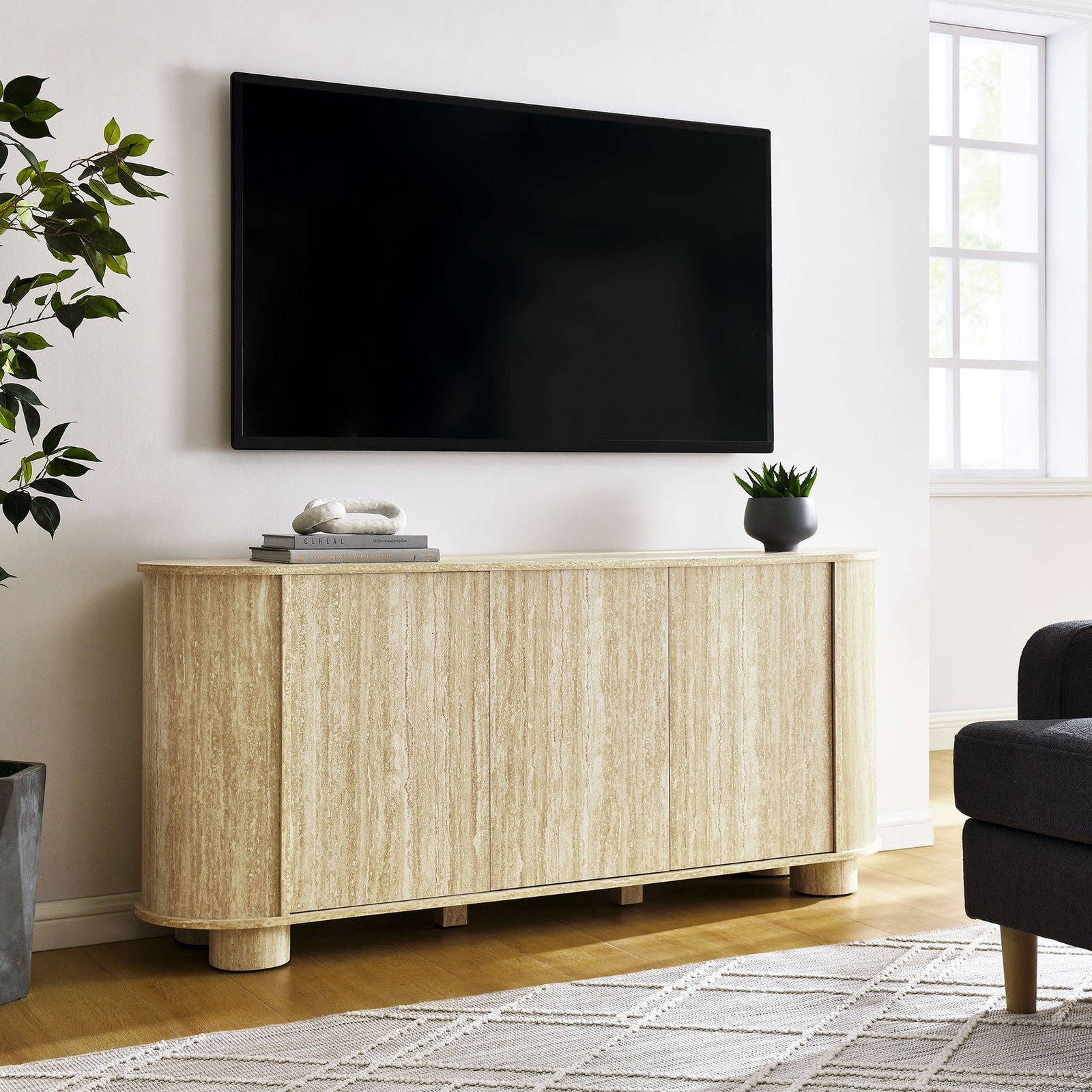 Faux travertine sideboard styled beneath a TV, offering concealed storage and a clean modern silhouette. || EEI-7015-TRA || front_angle_room