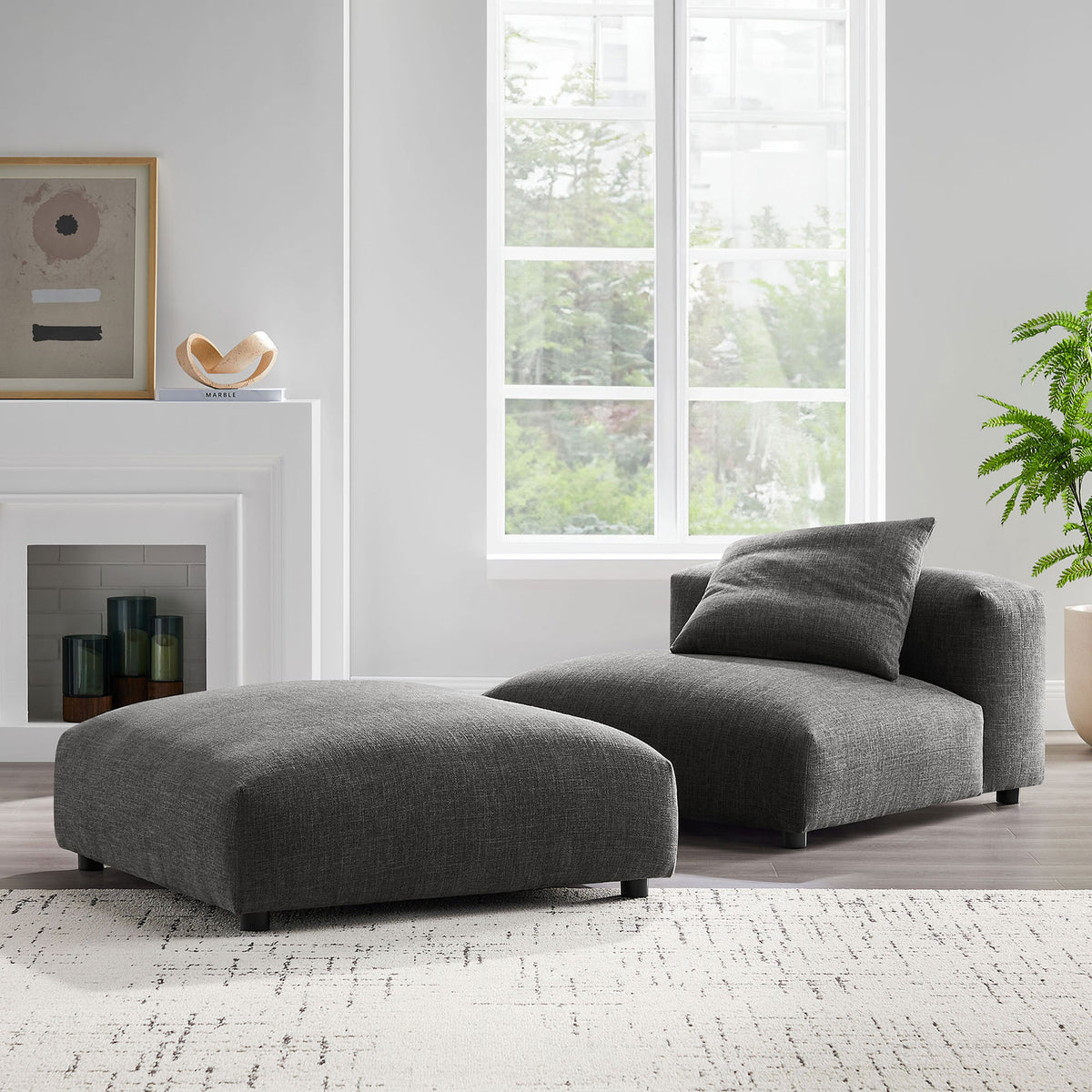 Modern armless chair and ottoman in charcoal fabric styled in a bright, airy living room || EEI-7023-CHA || front_angle_room