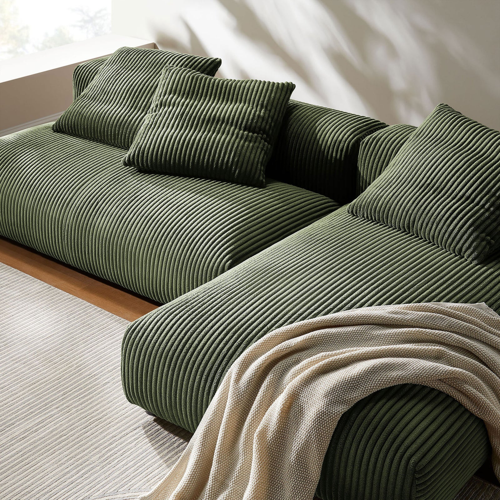 Plush fern corduroy sectional chaise styled with textured throw and cozy accent pillows || EEI-7024-FRN || detail_room