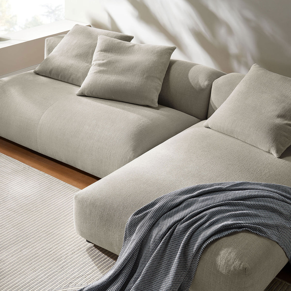 Close-up of linen modular sofa with chaise showing soft texture and cozy throw blanket || EEI-7025-LIN || detail_room