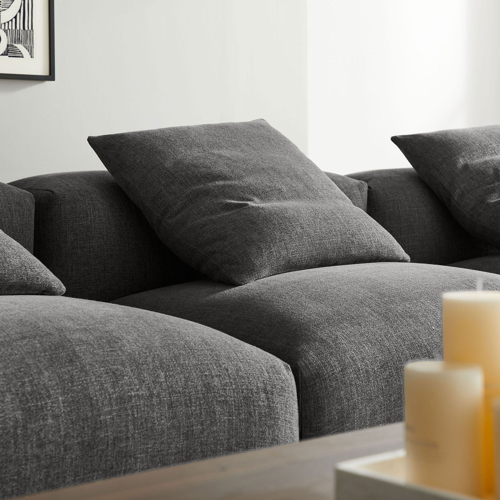 Charcoal textured upholstery and pillow-topped seats highlight the sofa's soft woven fabric finish || EEI-7027-CHA || detail_room