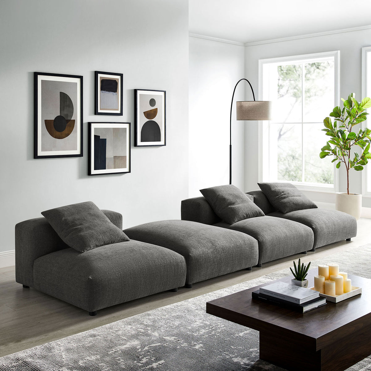 Charcoal modular sectional anchors a bright modern living room with generous seating and relaxed low-profile design || EEI-7027-CHA || front_angle_room