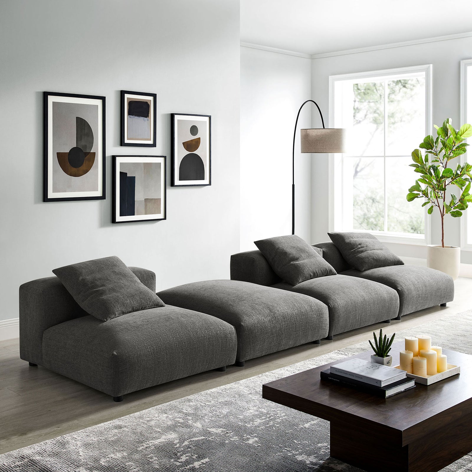 Charcoal modular sectional anchors a bright modern living room with generous seating and relaxed low-profile design || EEI-7027-CHA || front_angle_room