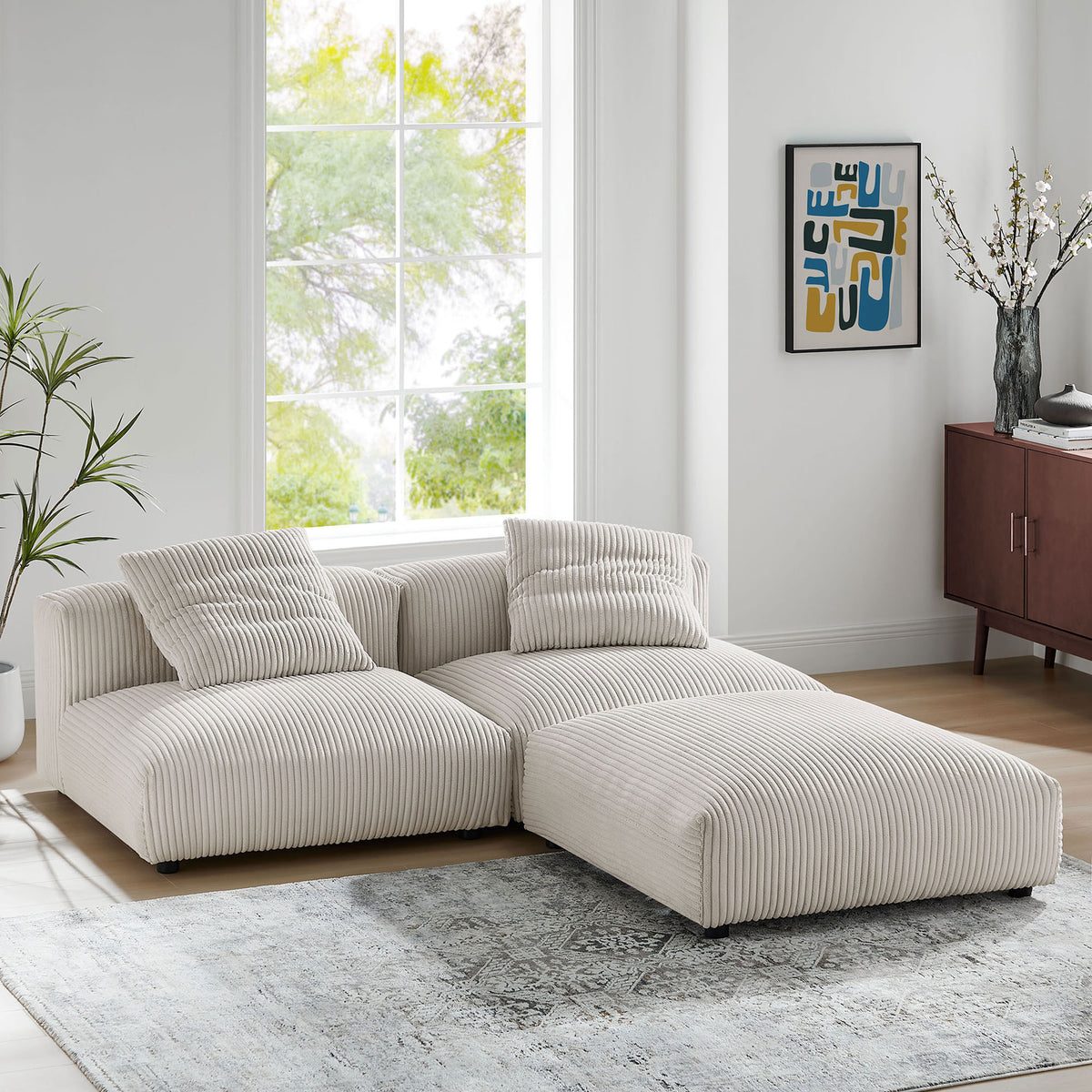 L-shaped Solace sectional styled in a bright living room with almond corduroy fabric and soft cushions || EEI-7028-ALM || front_angle_room