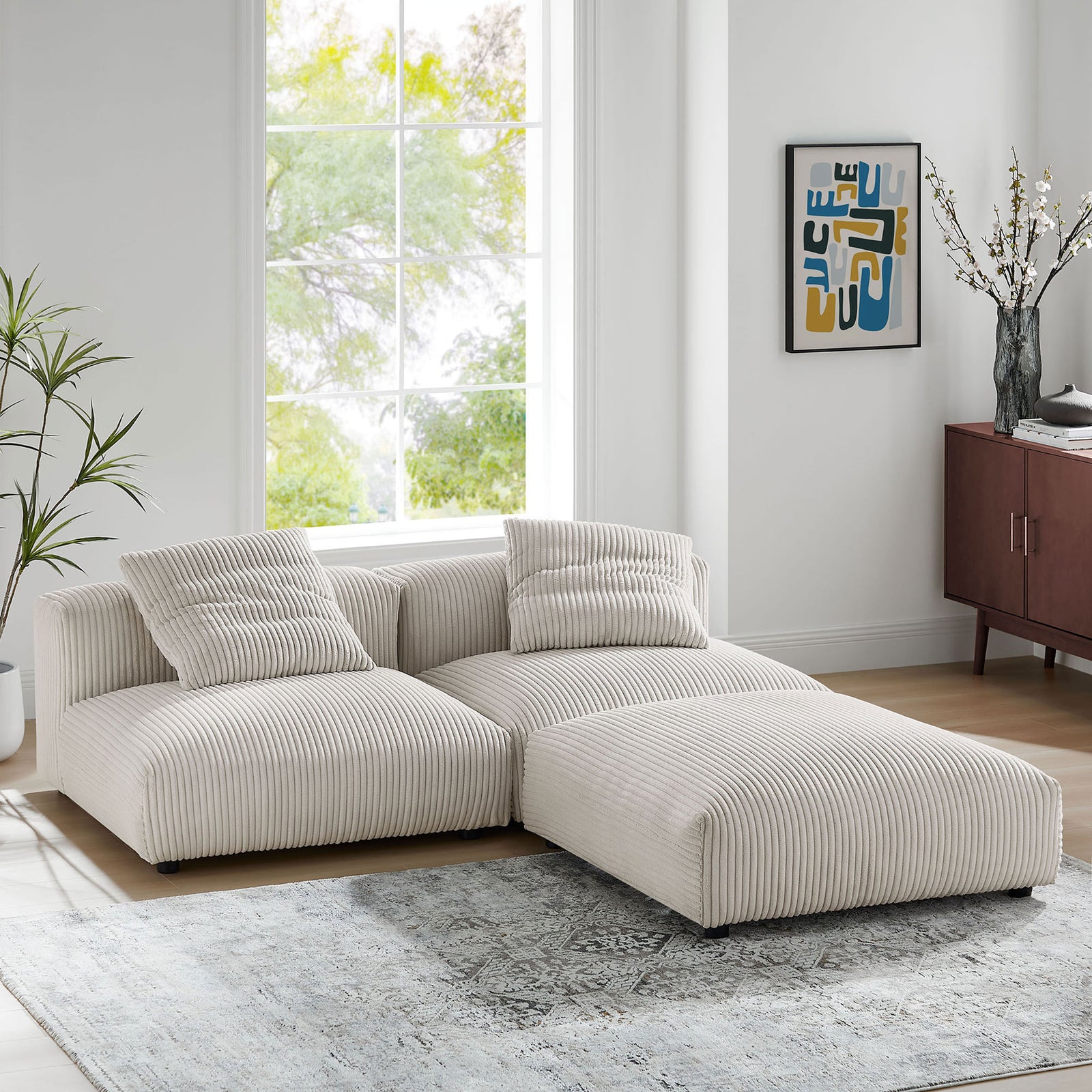 L-shaped Solace sectional styled in a bright living room with almond corduroy fabric and soft cushions || EEI-7028-ALM || front_angle_room