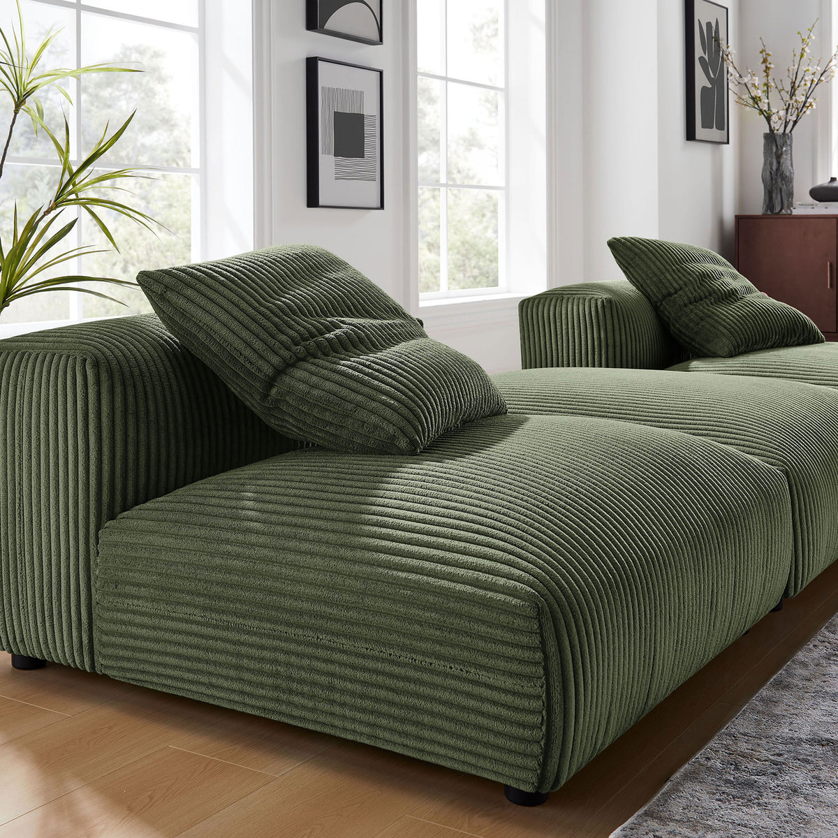 Fern corduroy modular sectional styled in a bright living room, highlighting deep ribbed texture and soft pillows. || EEI-7028-FRN || detail_room