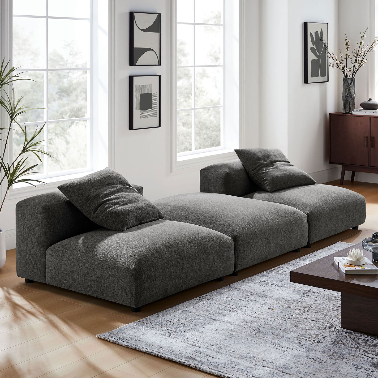 Charcoal modular sectional in a bright living room, pairing deep seats with clean modern lines || EEI-7029-CHA || front_angle_room