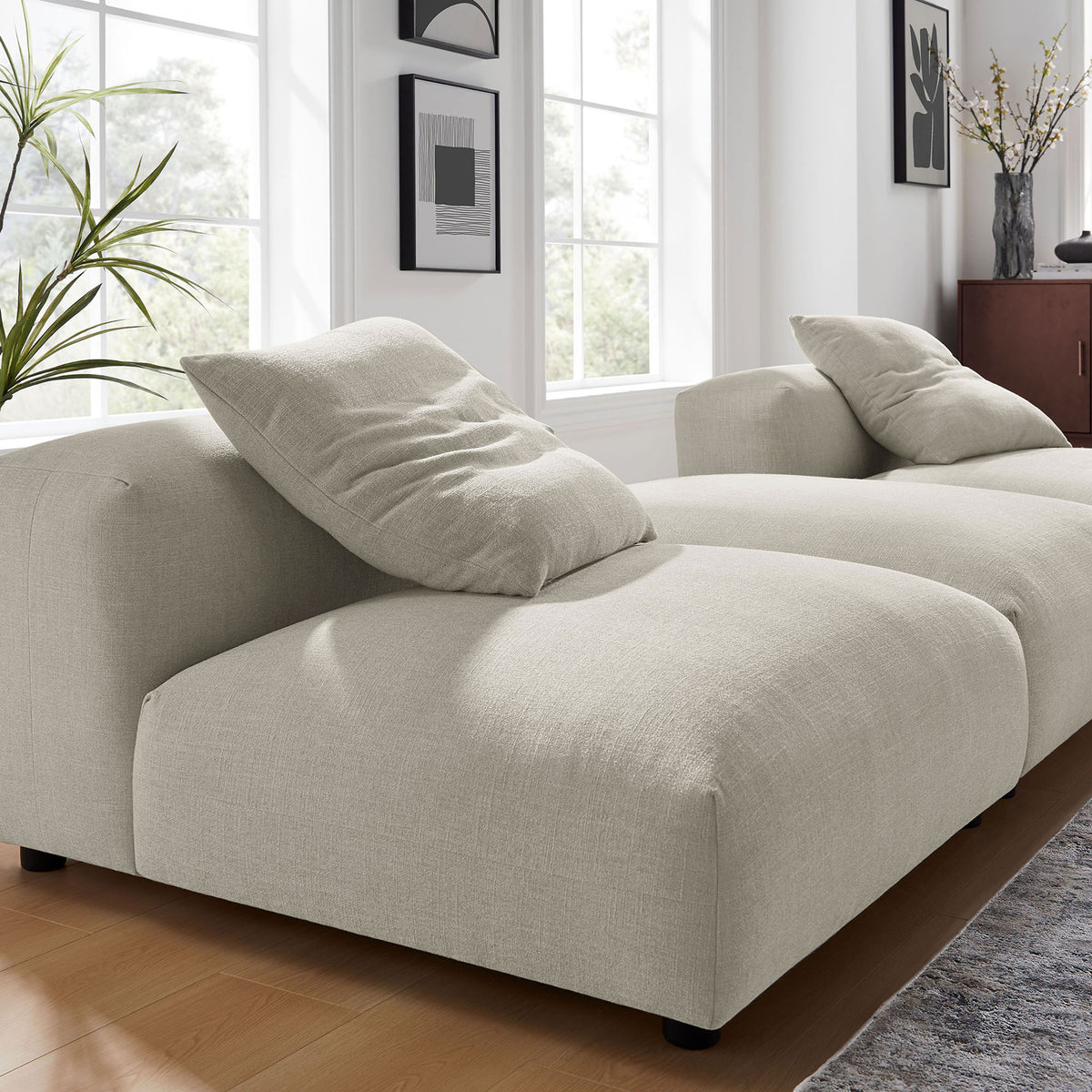 Textured linen upholstery and plush cushioning on the deep seat of the modular sectional || EEI-7029-LIN || detail_room