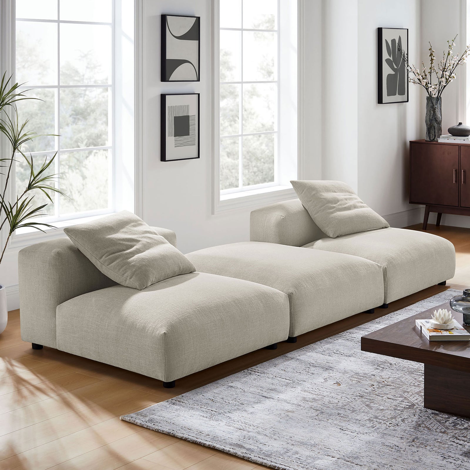 Linen modular sectional sofa styled in a bright living room with rug and coffee table || EEI-7029-LIN || front_angle_room