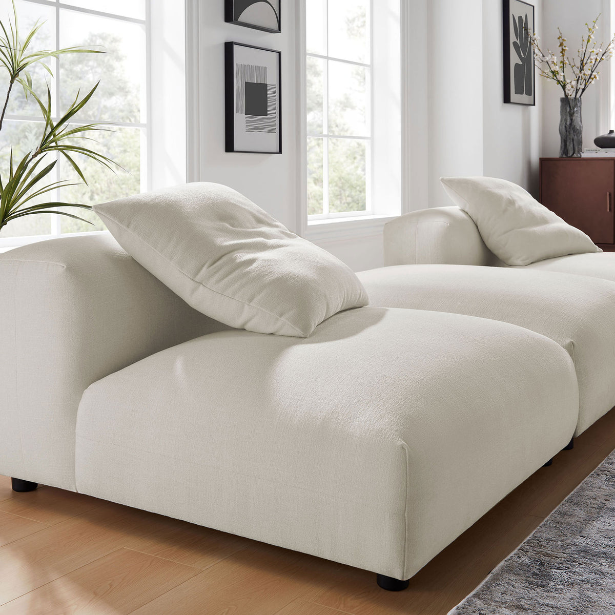 Textured salt woven upholstery and plush cushions create a soft, inviting seat on this modular sofa || EEI-7029-SAL || detail_room