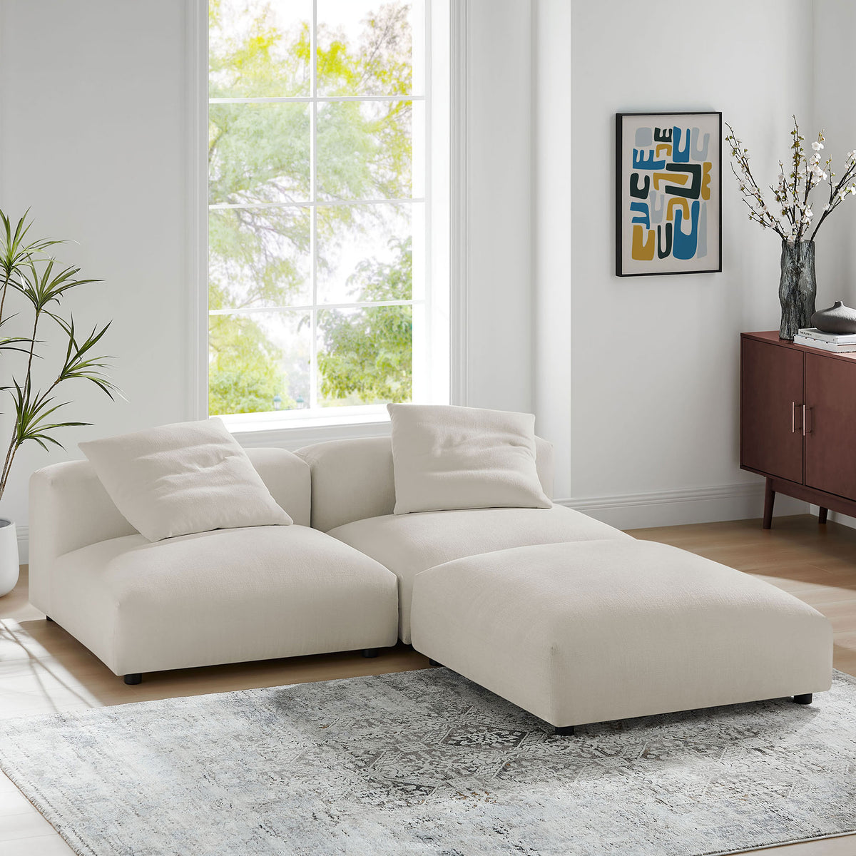 L-shaped salt modular sectional anchoring a modern living room with soft rug and minimalist decor || EEI-7029-SAL || front_angle_room