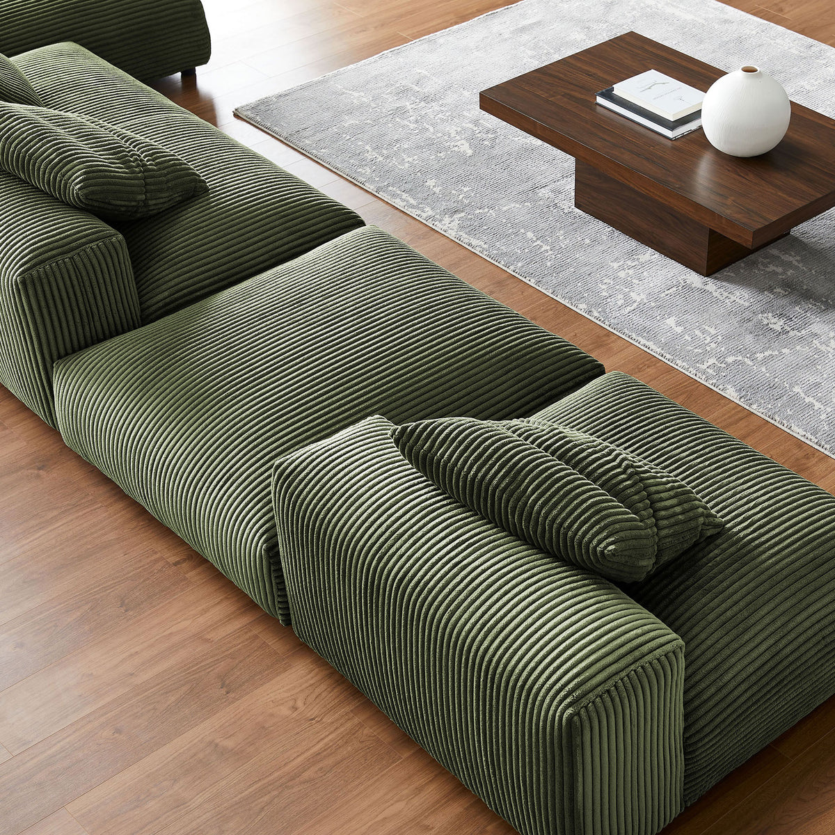 Detail of fern corduroy texture and deep cushions on the modular sectional in a modern room || EEI-7032-FRN || detail_room