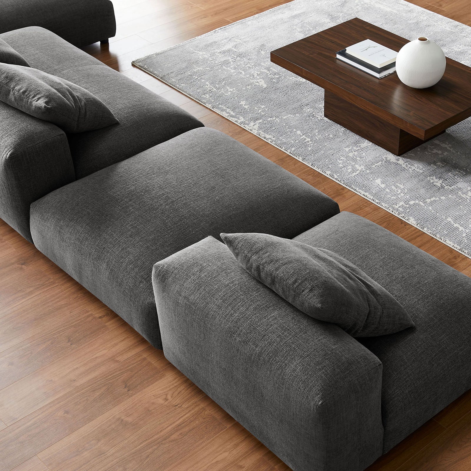 Close up of charcoal fabric sectional highlighting soft textured upholstery and generous seat cushioning || EEI-7033-CHA || detail_room