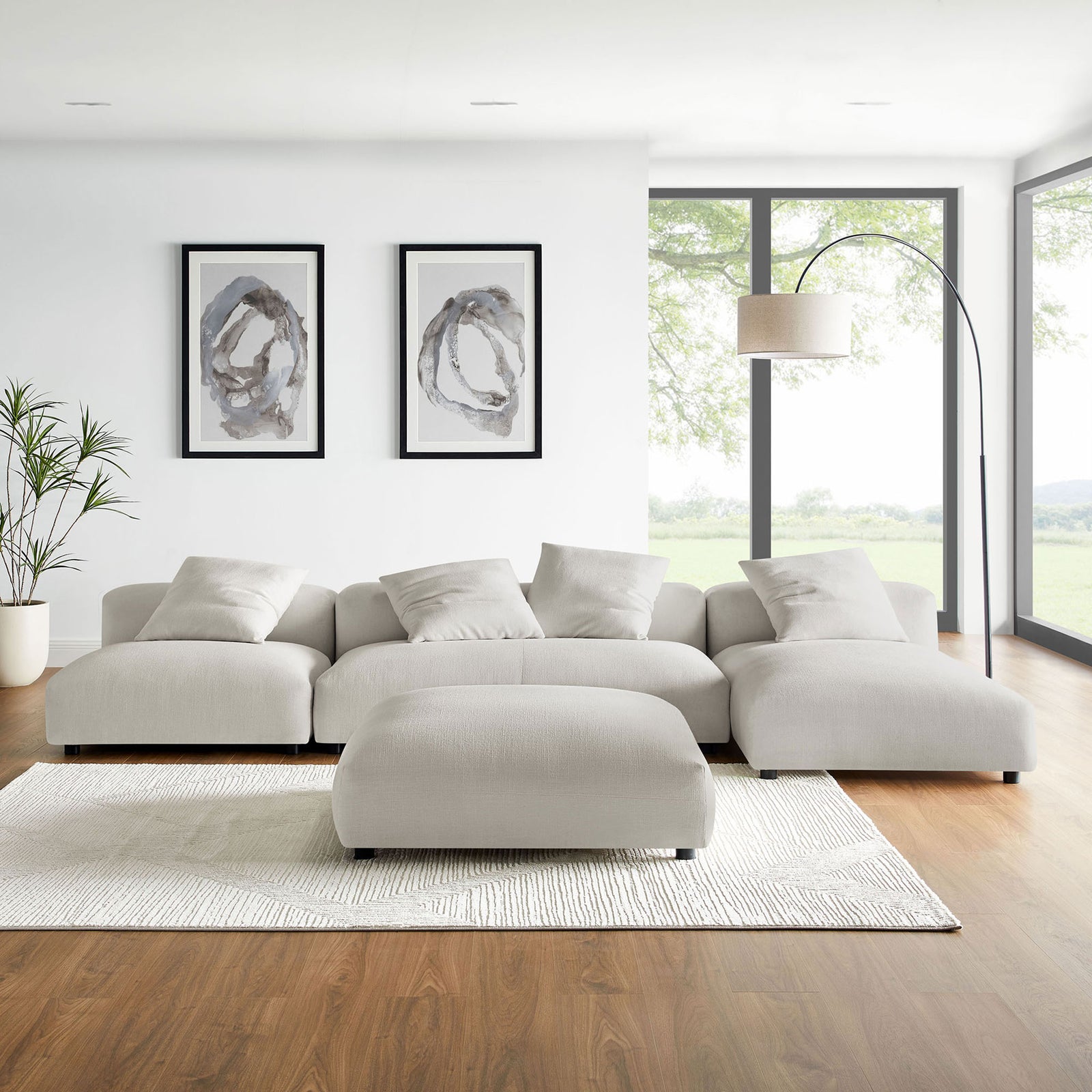 Salt fabric modular sectional with ottoman styled in a bright modern living room with rug, floor lamp, and artwork || EEI-7033-SAL || front_room