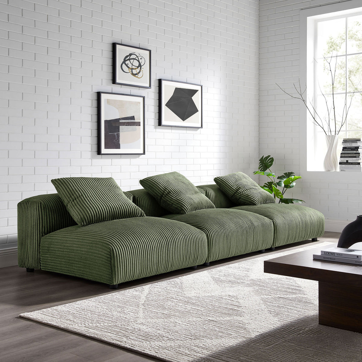 Fern green corduroy modular sofa styled in a bright living room with framed art and rug || EEI-7034-FRN || front_angle_multi_room