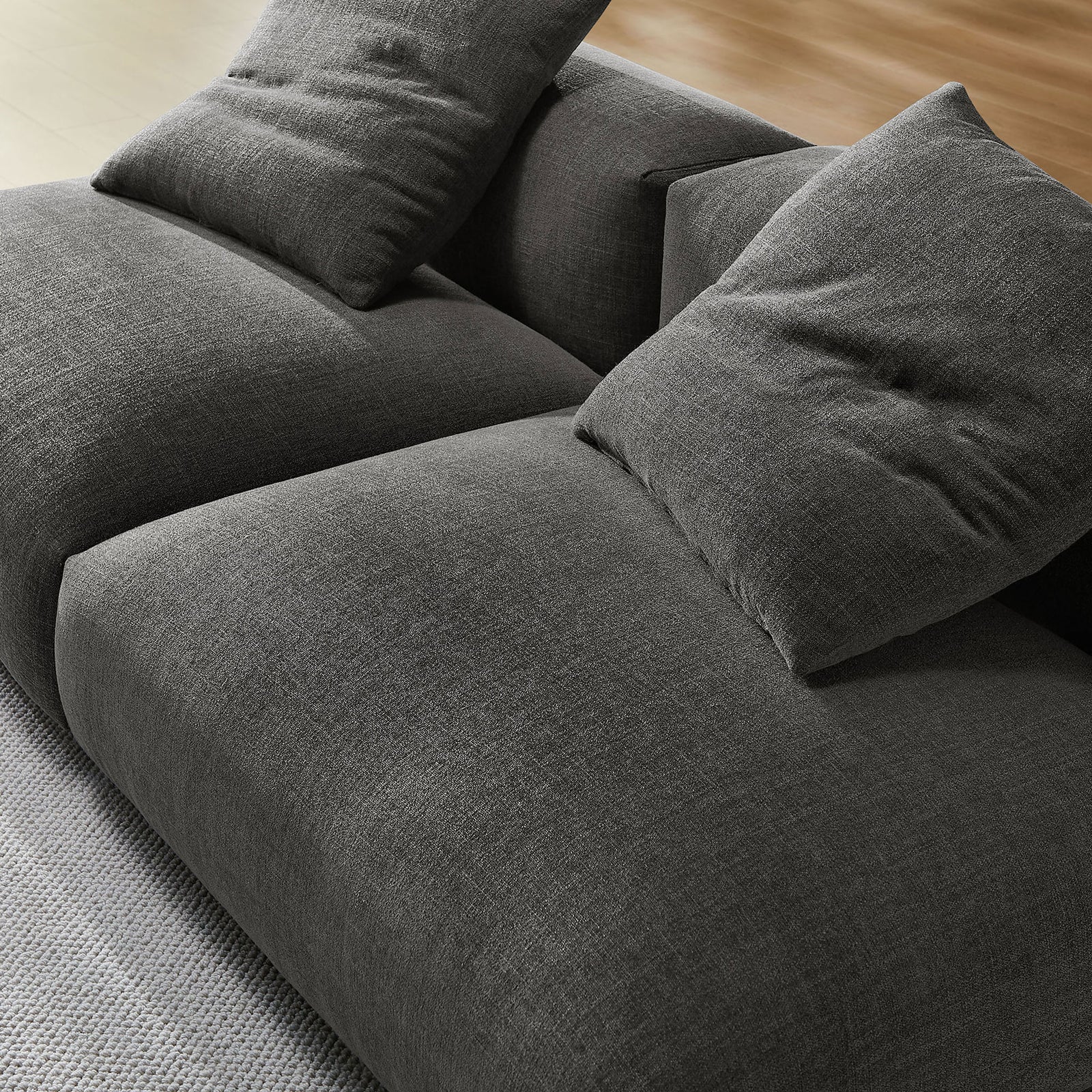Textured charcoal fabric and plush cushioning showcase the inviting softness of this modular sofa || EEI-7037-CHA || detail_room