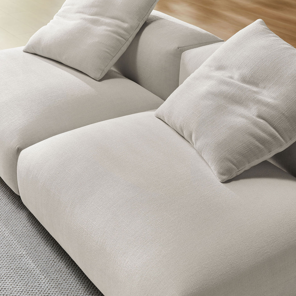 Textured salt fabric upholstery and plush cushions on the Solace modular sofa for relaxed lounging || EEI-7037-SAL || detail_room