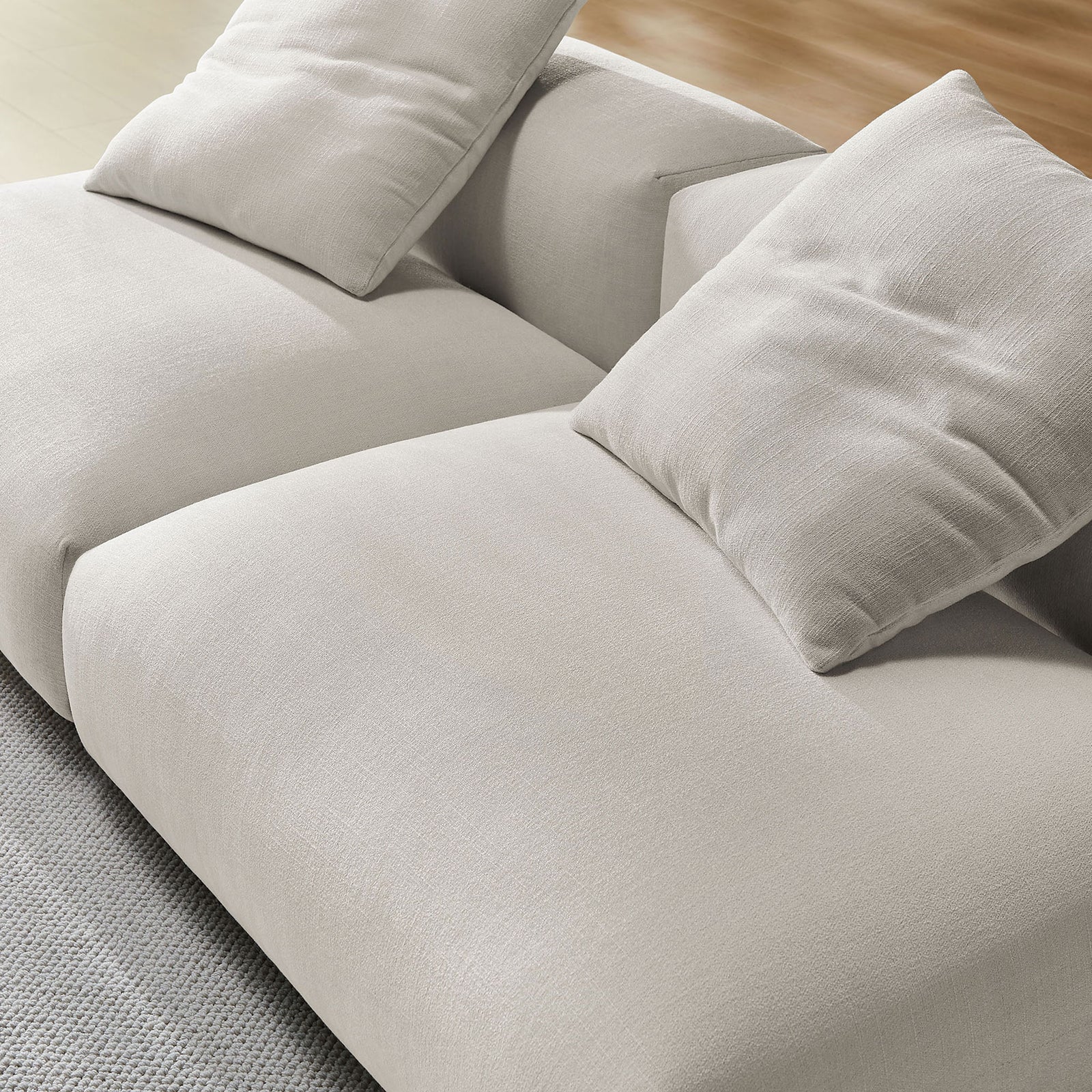 Textured salt fabric upholstery and plush cushions on the Solace modular sofa for relaxed lounging || EEI-7037-SAL || detail_room