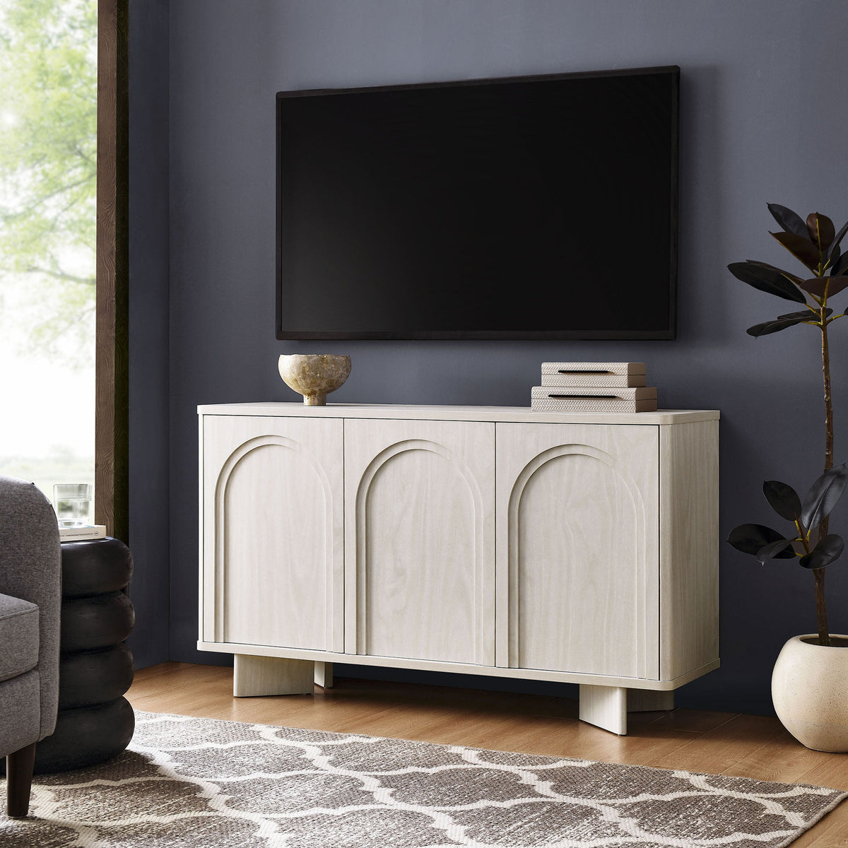 Flux sideboard styled as a media console beneath a wall-mounted TV in a modern living room || EEI-7039-WWA || front_angle_room