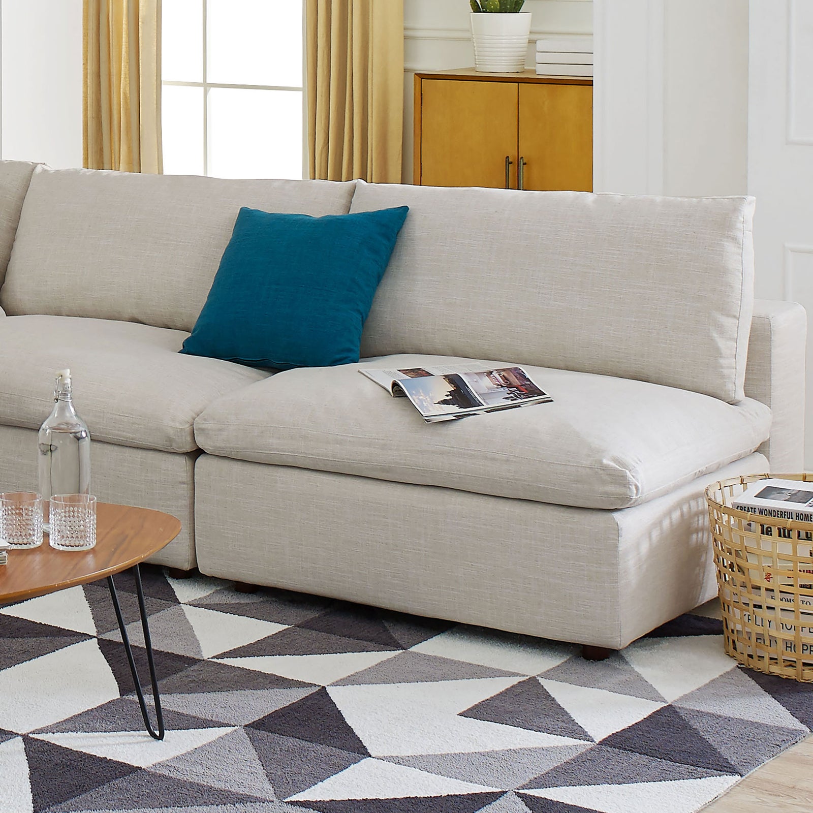 Beige armless sectional loveseat styled in a bright living room with blue pillow and decor || EEI-7042-BEI || detail_room