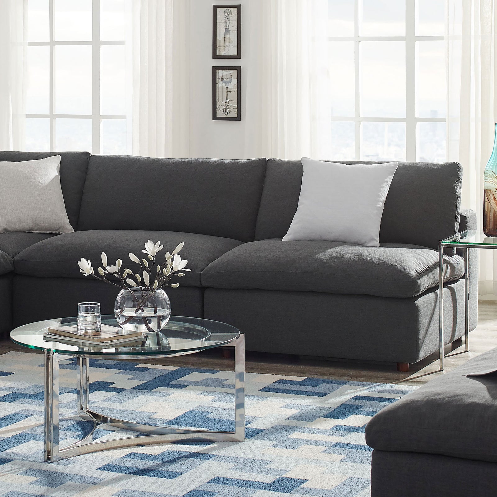 Gray Commix armless loveseat styled in a bright living room with glass coffee table and geometric rug || EEI-7042-GRY || front_angle_room