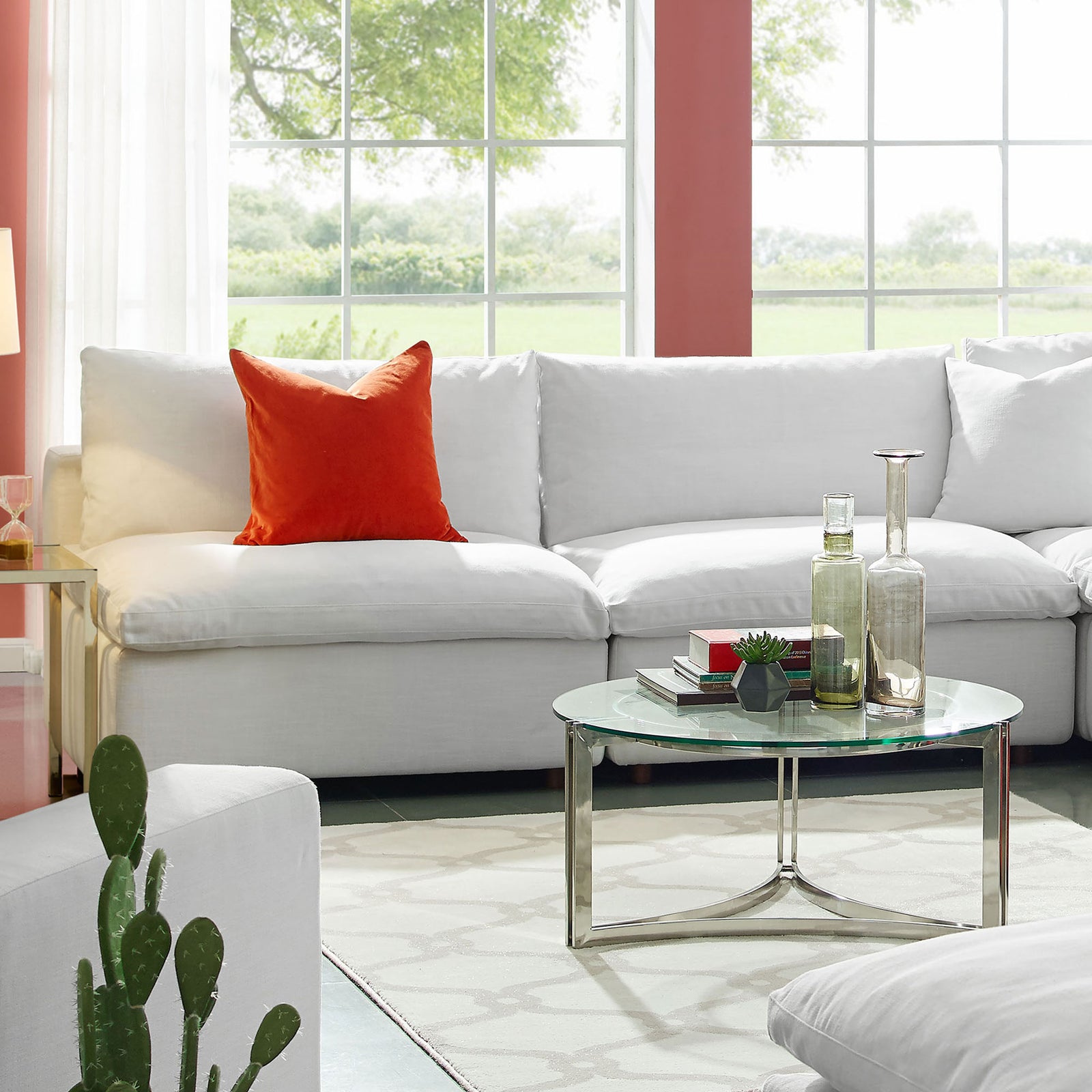 White Commix armless loveseat styled in a bright living room, inviting cozy relaxation with its overstuffed cushions || EEI-7042-WHI || front_angle_room
