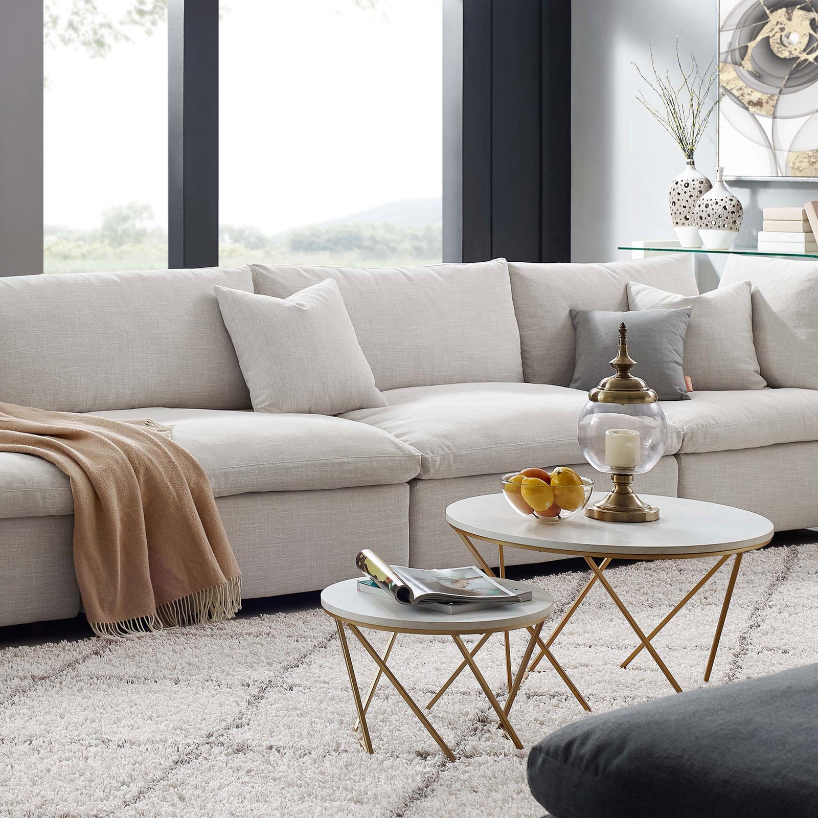 Beige Commix sectional anchored in a modern living room with soft rug, accent tables, and cozy throw. || EEI-7043-BEI || front_angle_room