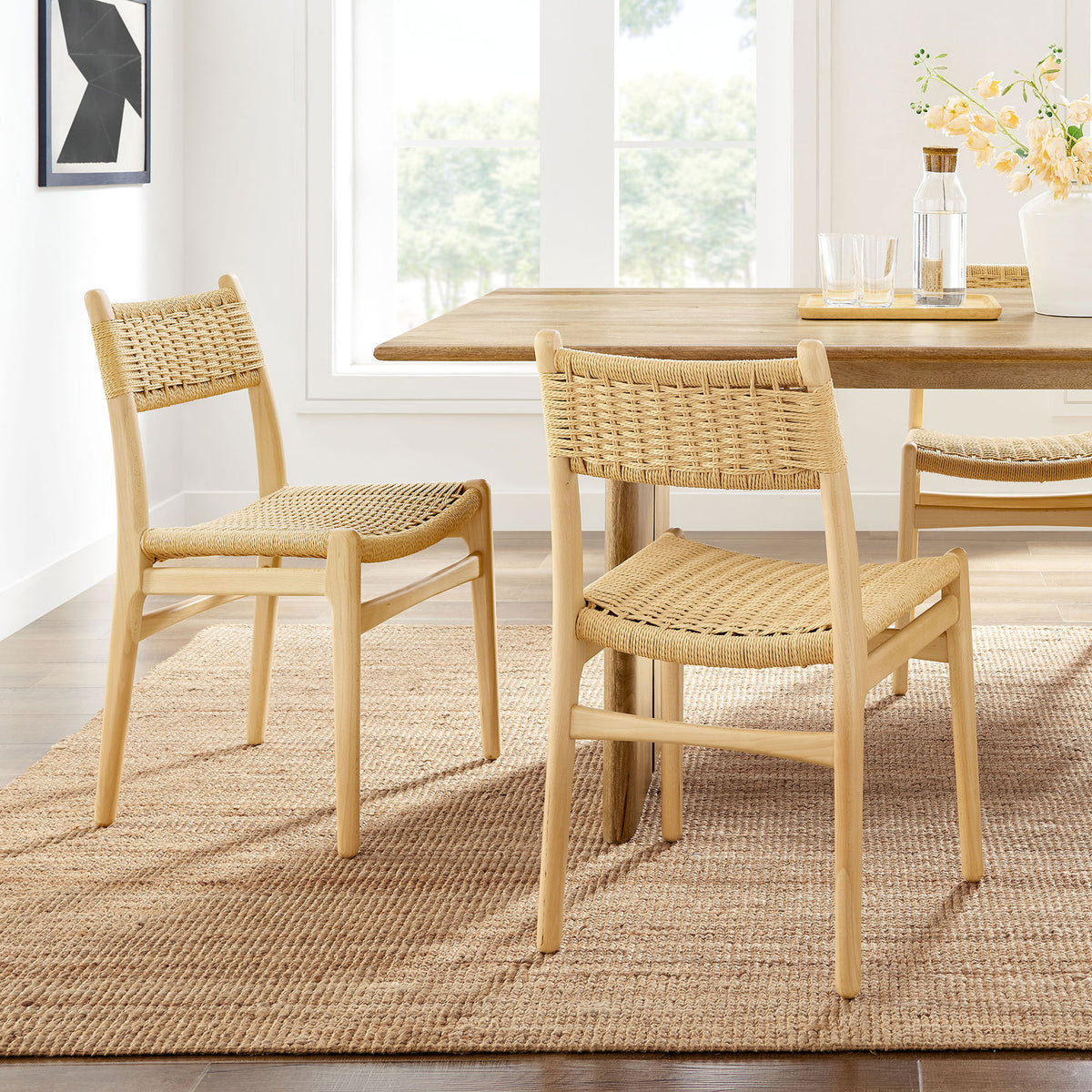 Pair of natural rope and wood dining chairs styled around a warm, modern farmhouse dining table. || EEI-7044-NAT-NAT || front_angle_multi_room