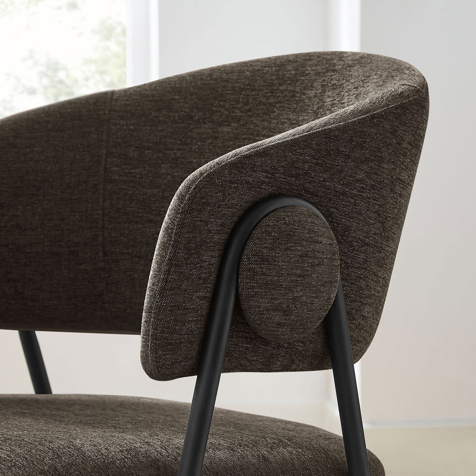 Barrel arm and round side accent of the Nella java black dining chair in a contemporary dining space || EEI-7045-JAV-BLK || detail_room