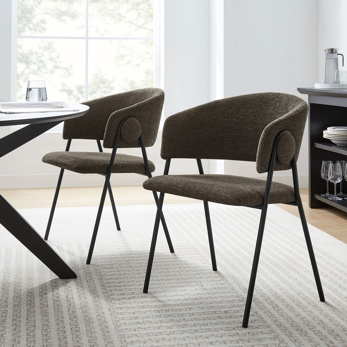 Pair of Nella java black dining chairs styled around a modern table in a bright dining room || EEI-7045-JAV-BLK || front_angle_multi_room