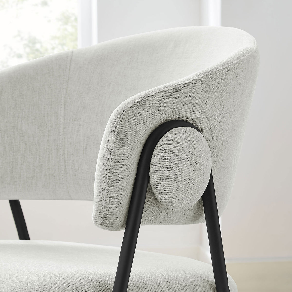 Barrel dining chair beside a window highlighting textured fabric and round side button detail || EEI-7045-NPT-BLK || detail_room
