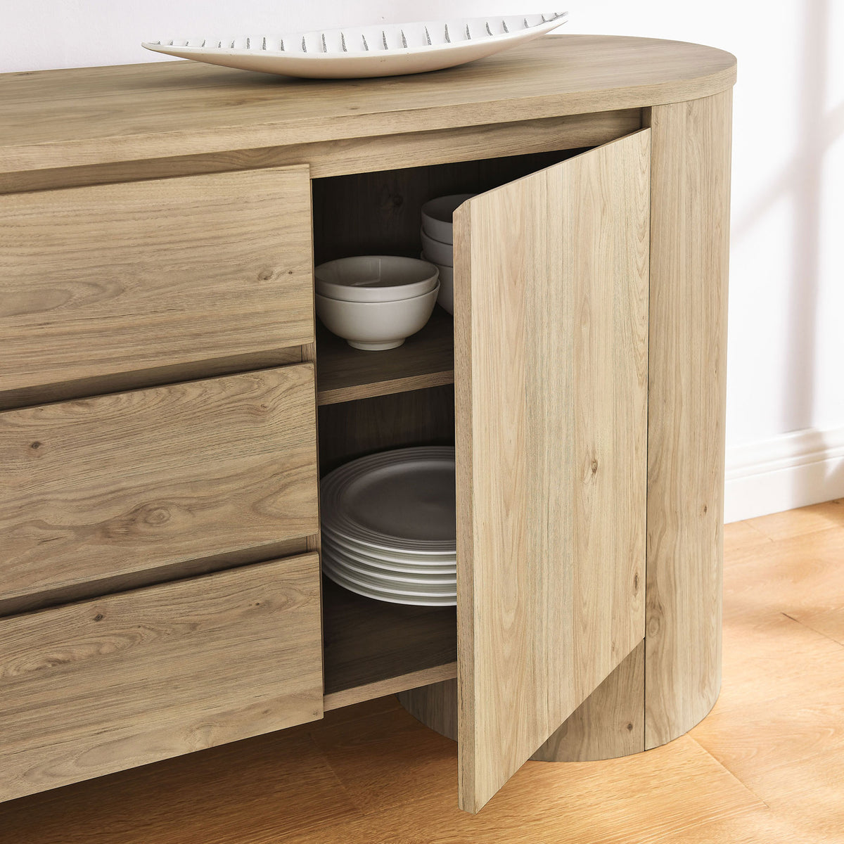 Open cabinet of the Duval sideboard displaying stacked dishes and adjustable shelves in a hickory finish || EEI-7050-HCK || storage_open_room