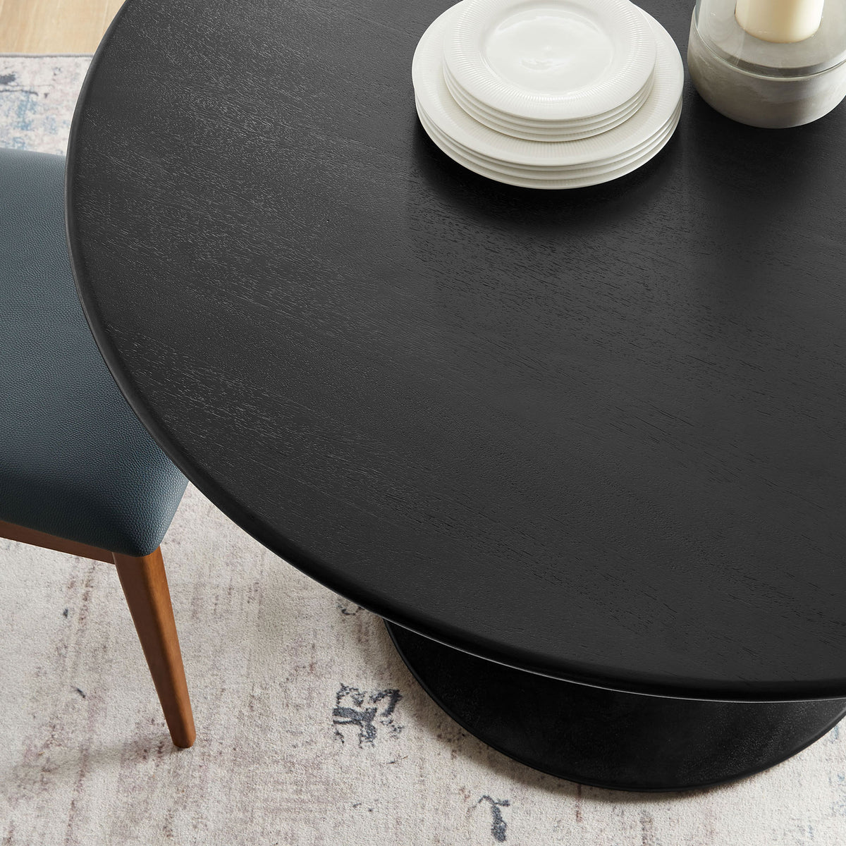 Styled black round dining table top with place settings and decor in a modern dining room || EEI-7051-BLK || detail_room