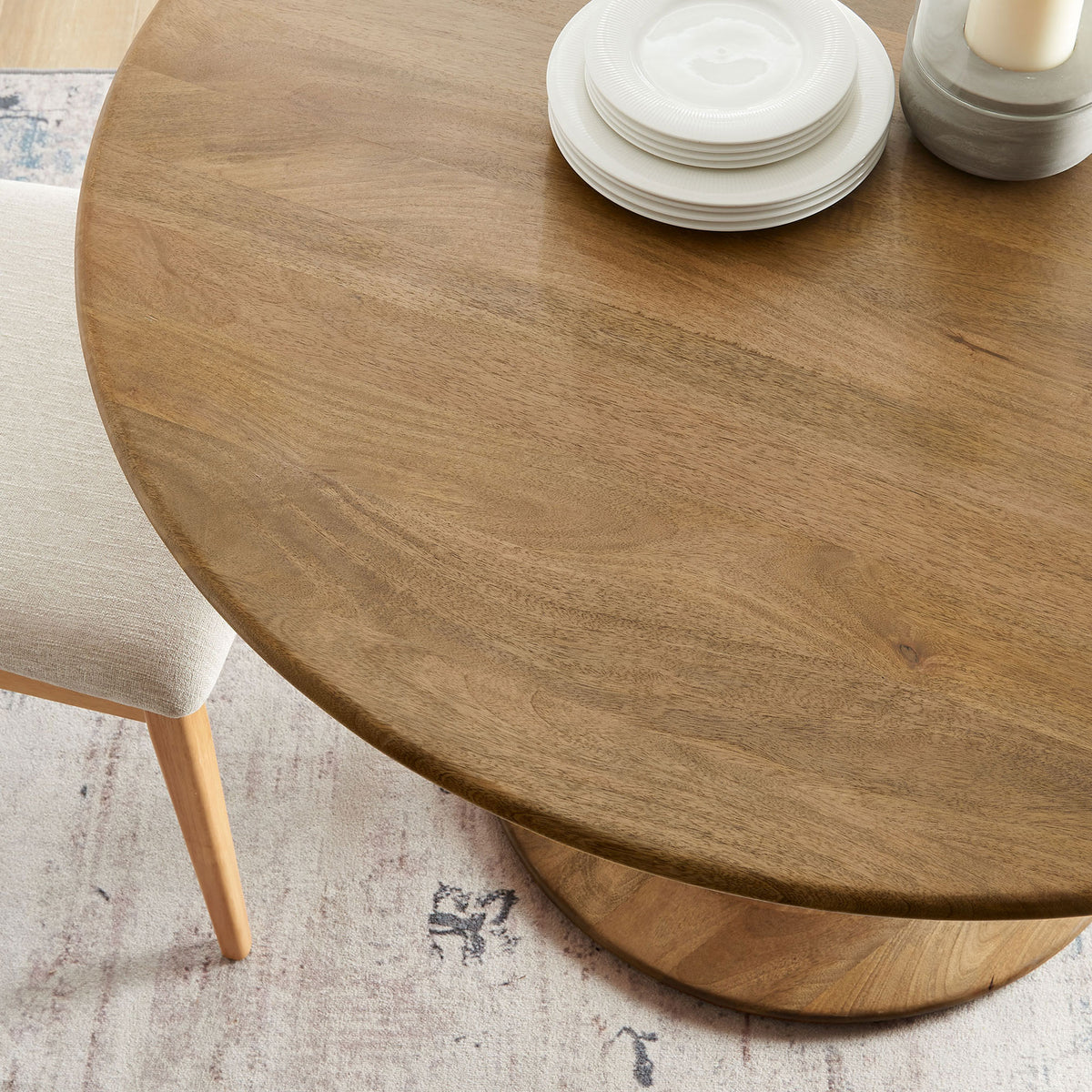 Natural wood dining tabletop styled with plates and candles in a cozy room setting || EEI-7051-NAT || detail_room
