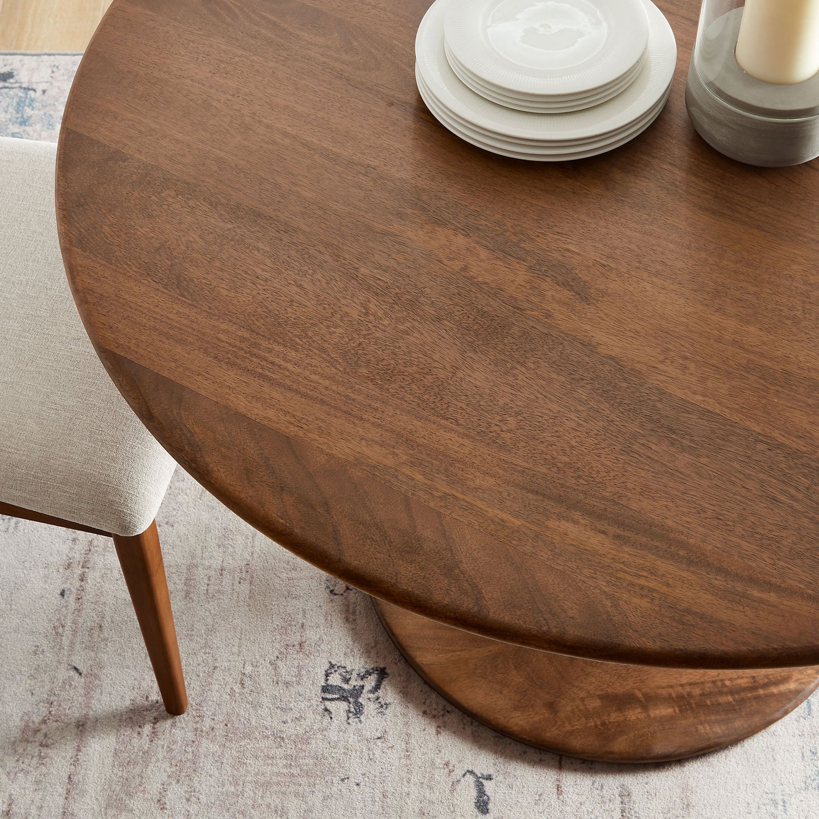 Walnut dining tabletop styled with neutral dinnerware adds inviting warmth to a modern dining space. || EEI-7051-WAL || detail_room