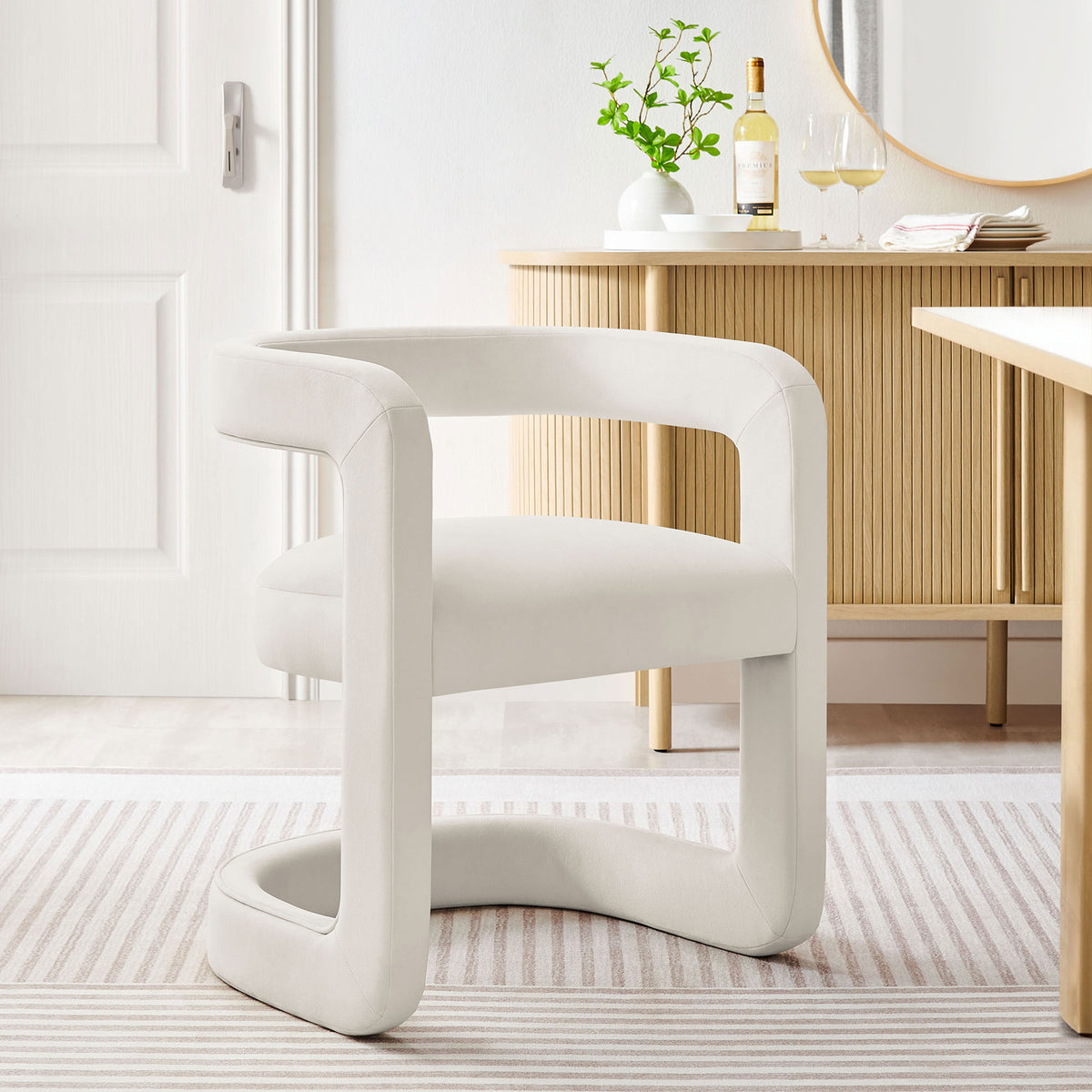 Alabaster velvet barrel dining chair adds modern elegance to a bright dining room setting. || EEI-7052-ALA || front_angle_room