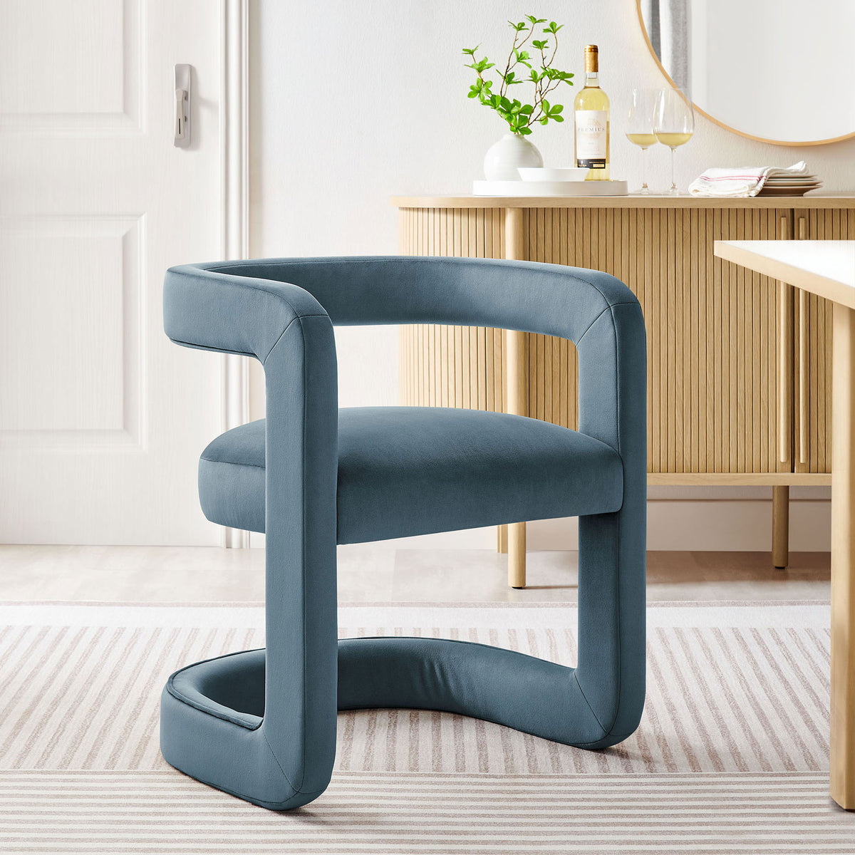 Cadet blue velvet barrel dining chair adding modern elegance to a light dining room with warm wood furniture || EEI-7052-CAB || front_angle_room