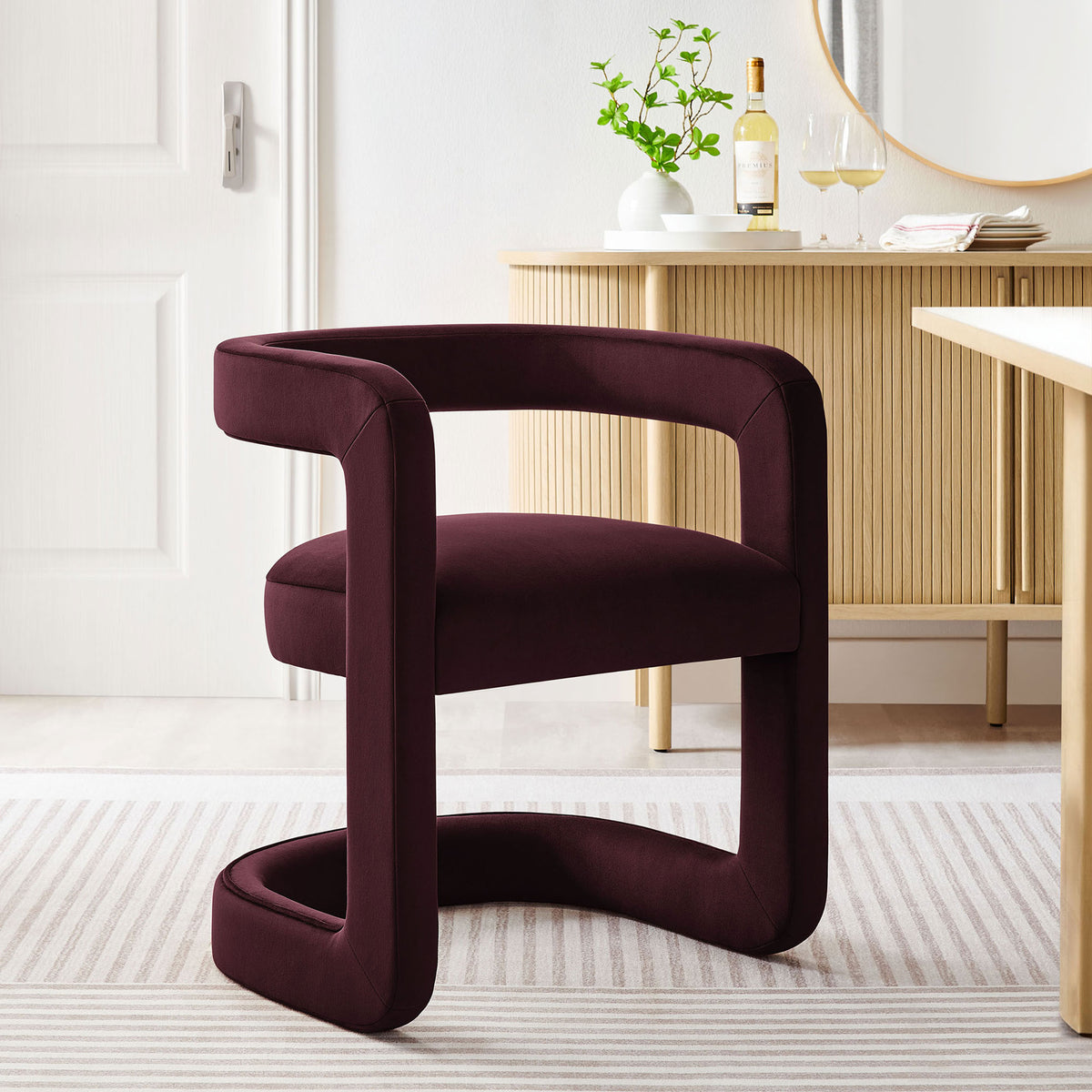 Winslow mulberry velvet dining chair lends warm contrast to a bright contemporary dining space with wood accents. || EEI-7052-MUL || front_angle_room