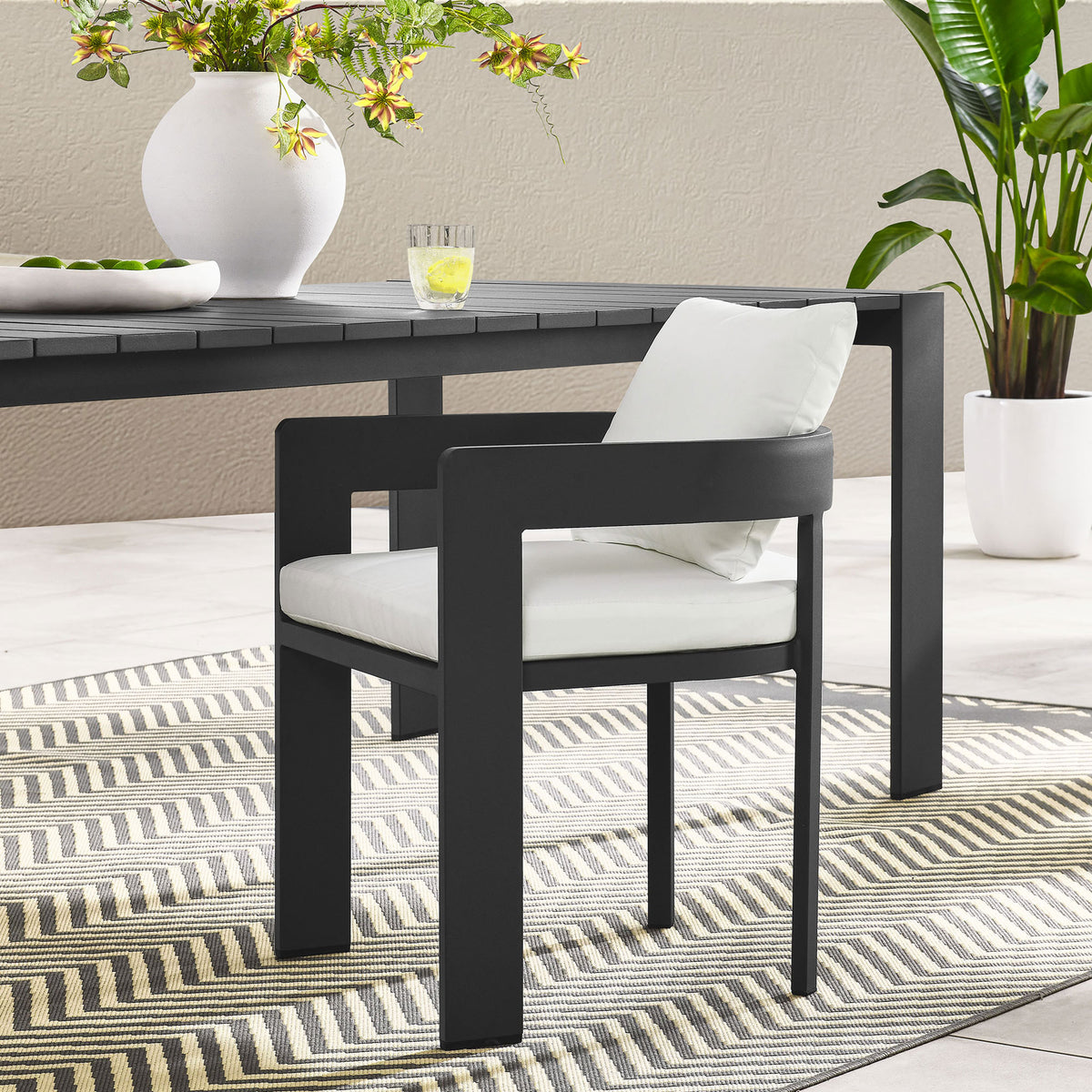 Charcoal Tahoe patio dining chair with white cushions styled around a modern outdoor dining table || EEI-7053-GRY-WHI || front_angle_room
