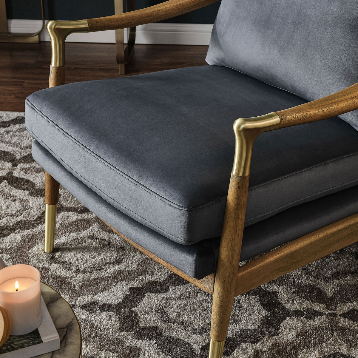 Plush performance velvet seat with curved wood arm and brass accent in a warm space || EEI-7056-CAB-WAL || detail_room