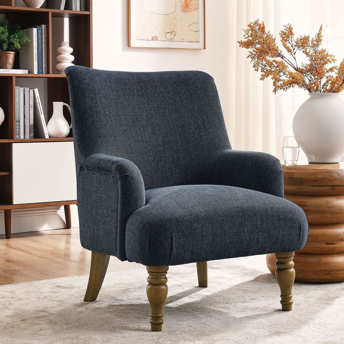 Elegant slate blue chair adds timeless style with plush seat and turned wood legs in a cozy room || EEI-7057-SLB || front_angle_room