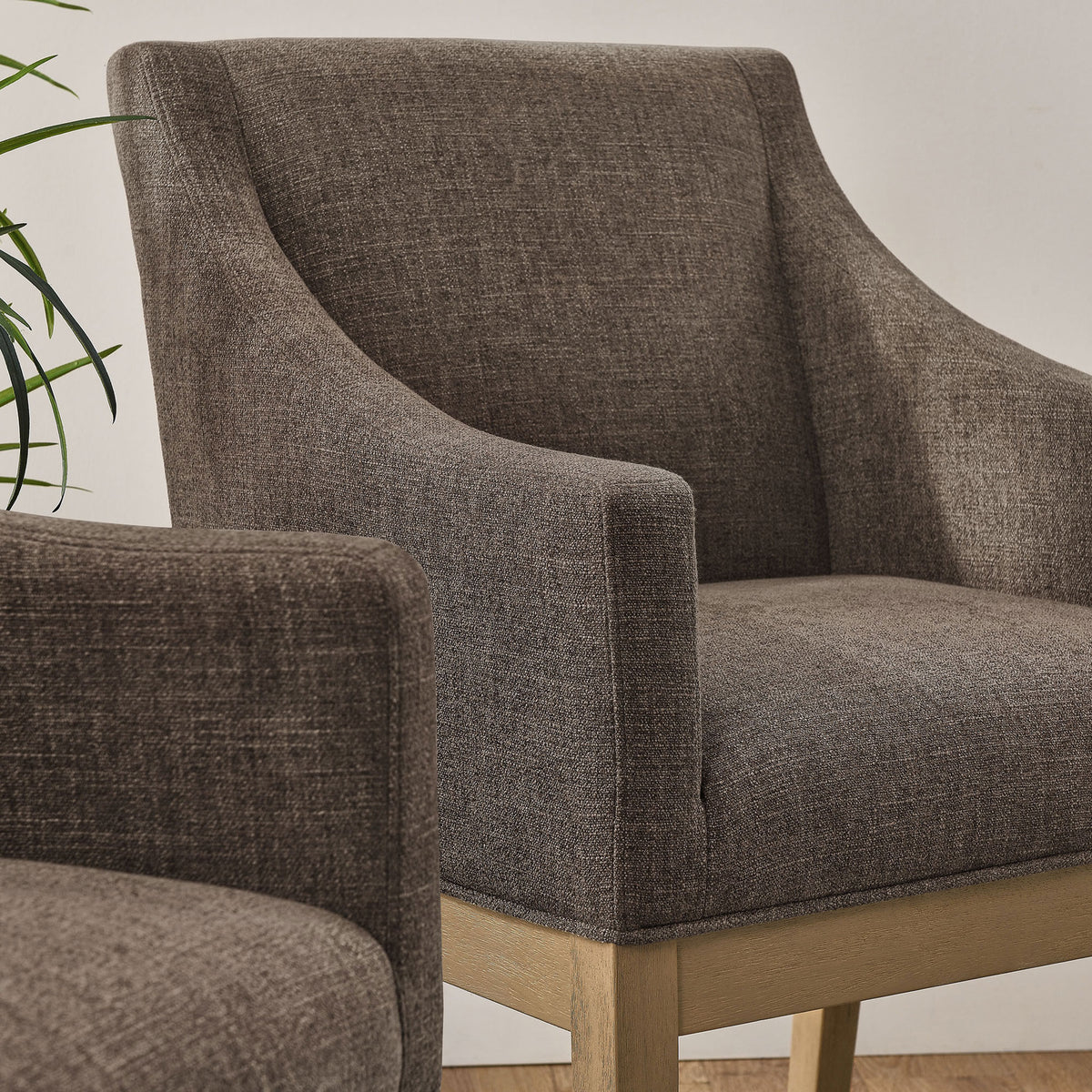 Pair of mocha upholstered dining armchairs bringing soft texture and warmth to a modern room || EEI-7058-MOC-NAT || detail_room