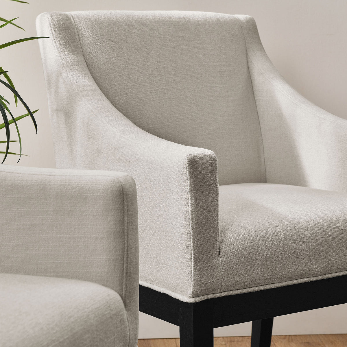 Alton upholstered dining armchairs bring inviting texture and comfort to a bright, modern room || EEI-7058-SAL-BLK || front_angle_room