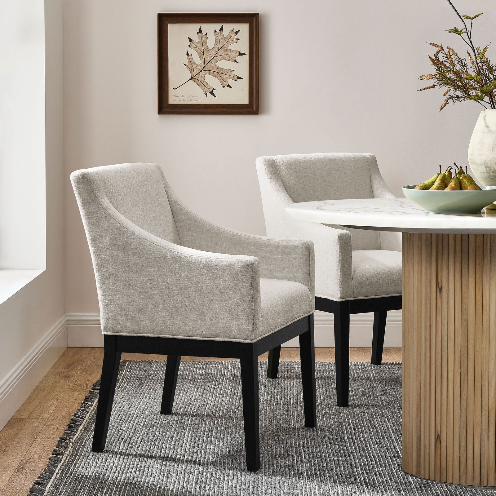 Alton dining armchairs pair with a modern table to create a cozy, contemporary dining setting || EEI-7058-SAL-BLK || front_angle_room