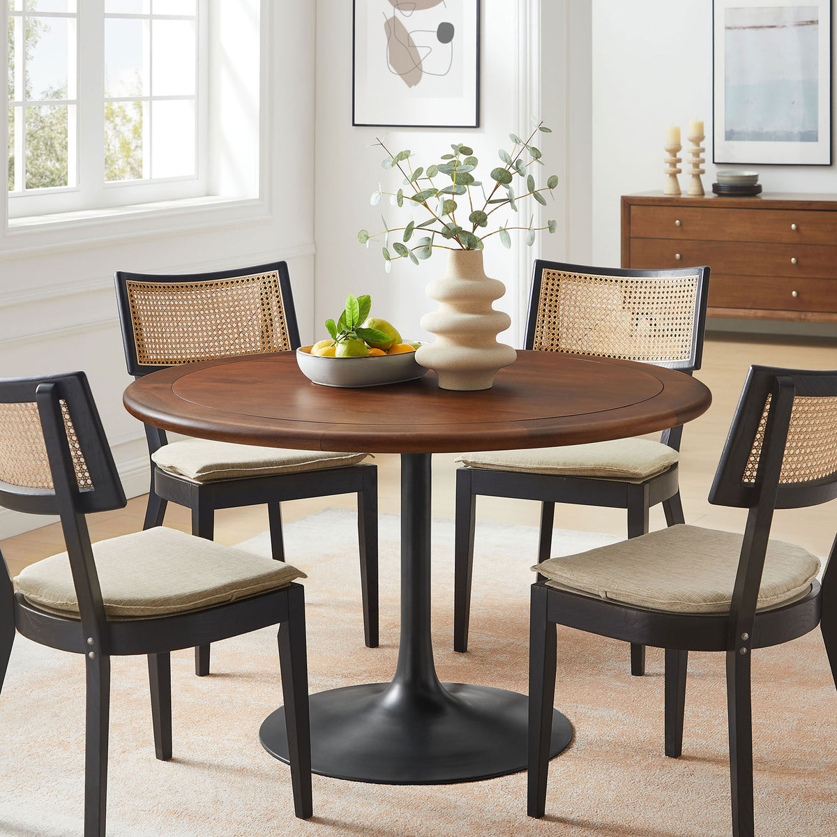 48 inch round pedestal dining table with black base paired with four upholstered cane back chairs. || EEI-7070-BLK-WAL || front_angle_room