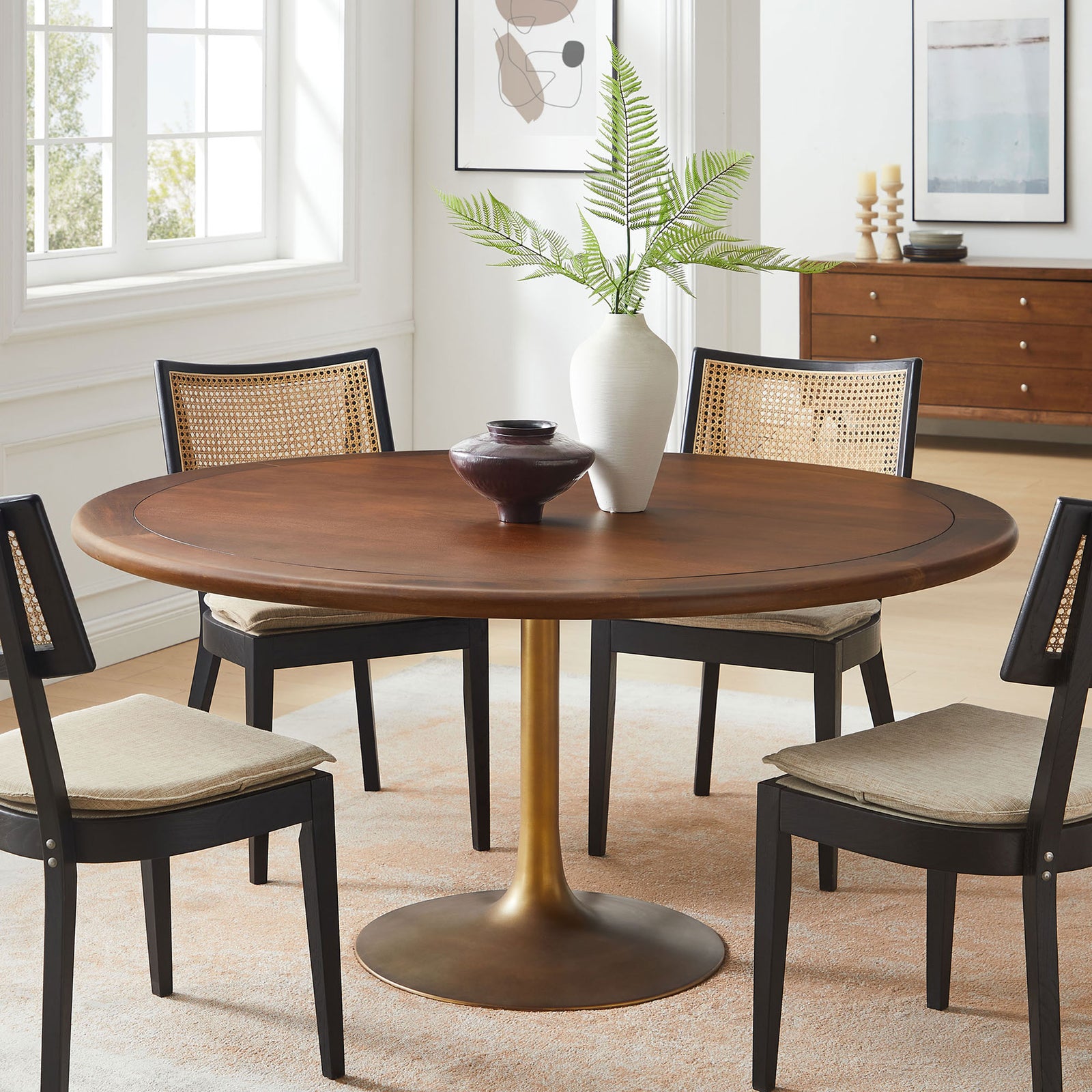 Large round walnut pedestal dining table styled in a bright dining room, ideal for comfortable six person meals || EEI-7071-BRA-WAL || front_room